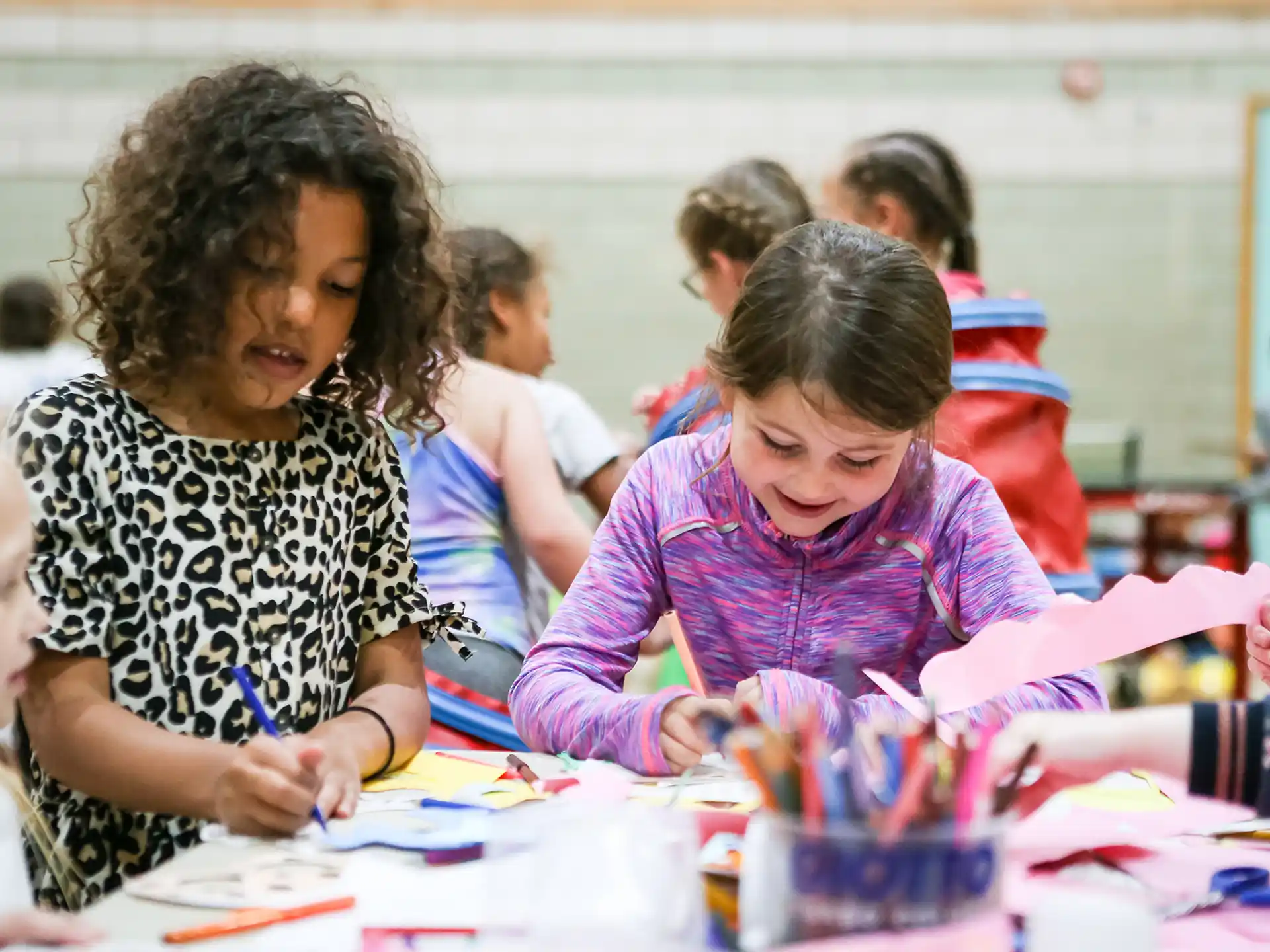 a group of children sitting at a table