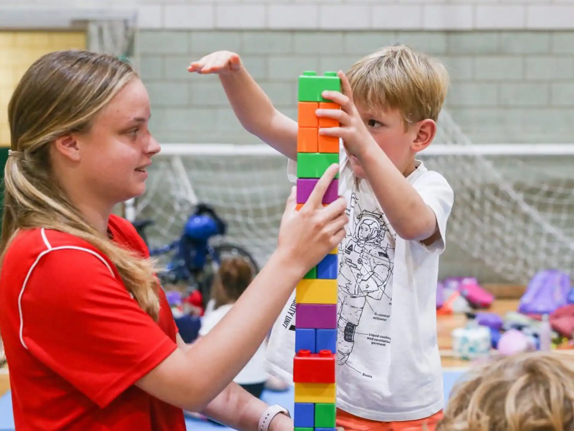 a person and a child playing with toys