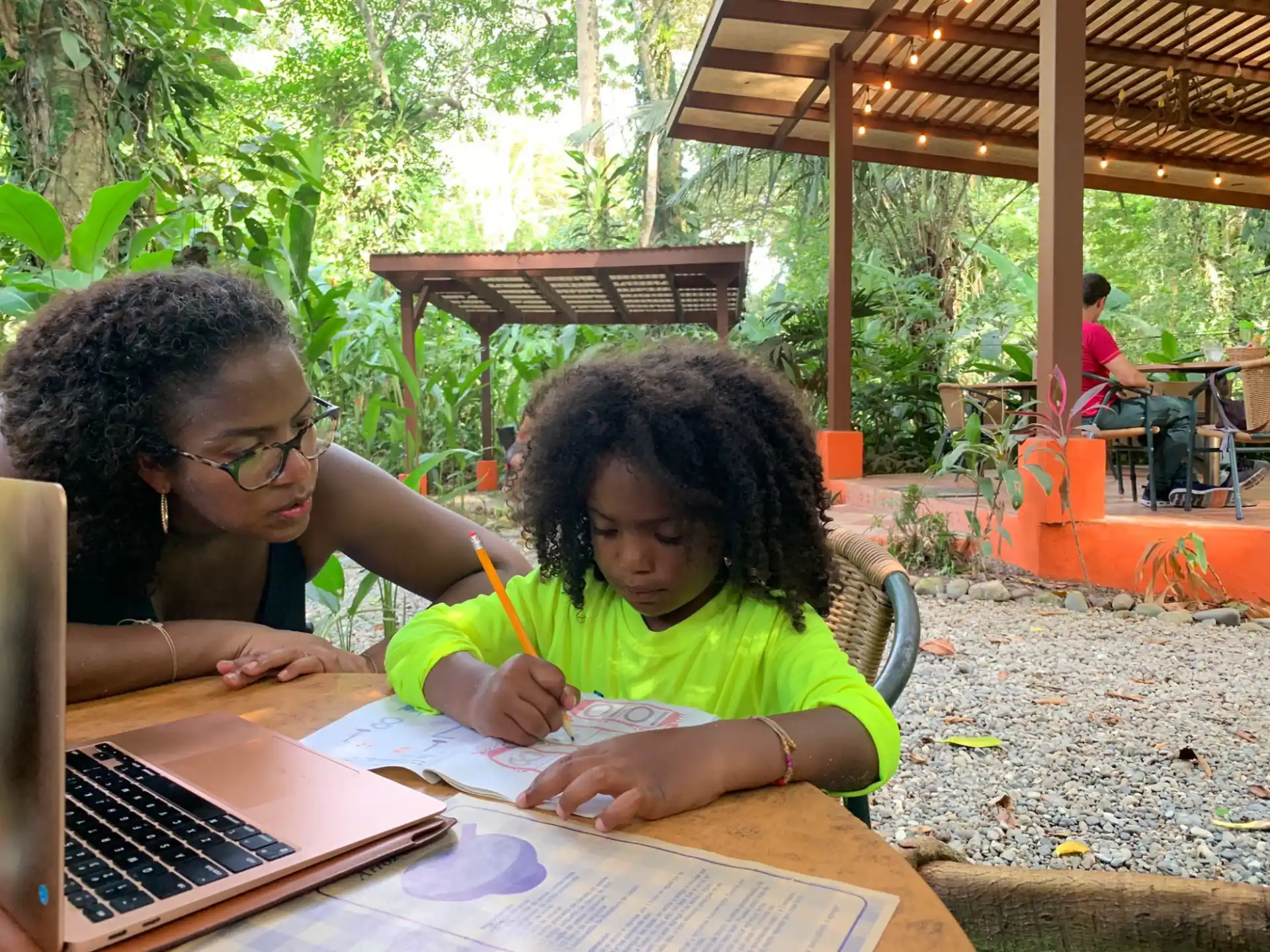 a person and a girl studying outside