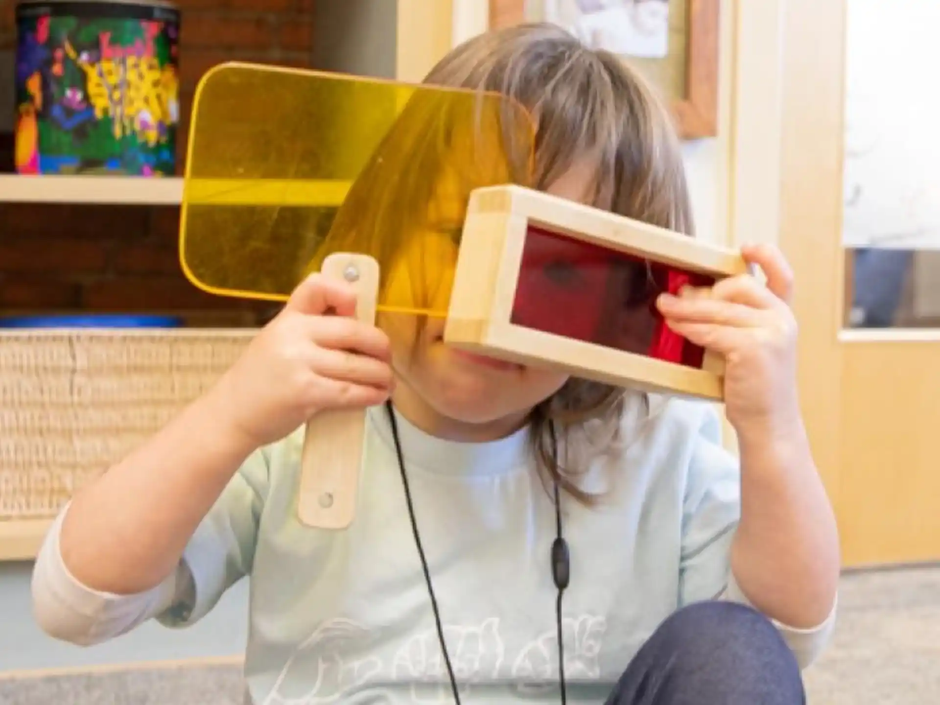 a girl holding a device to her ear