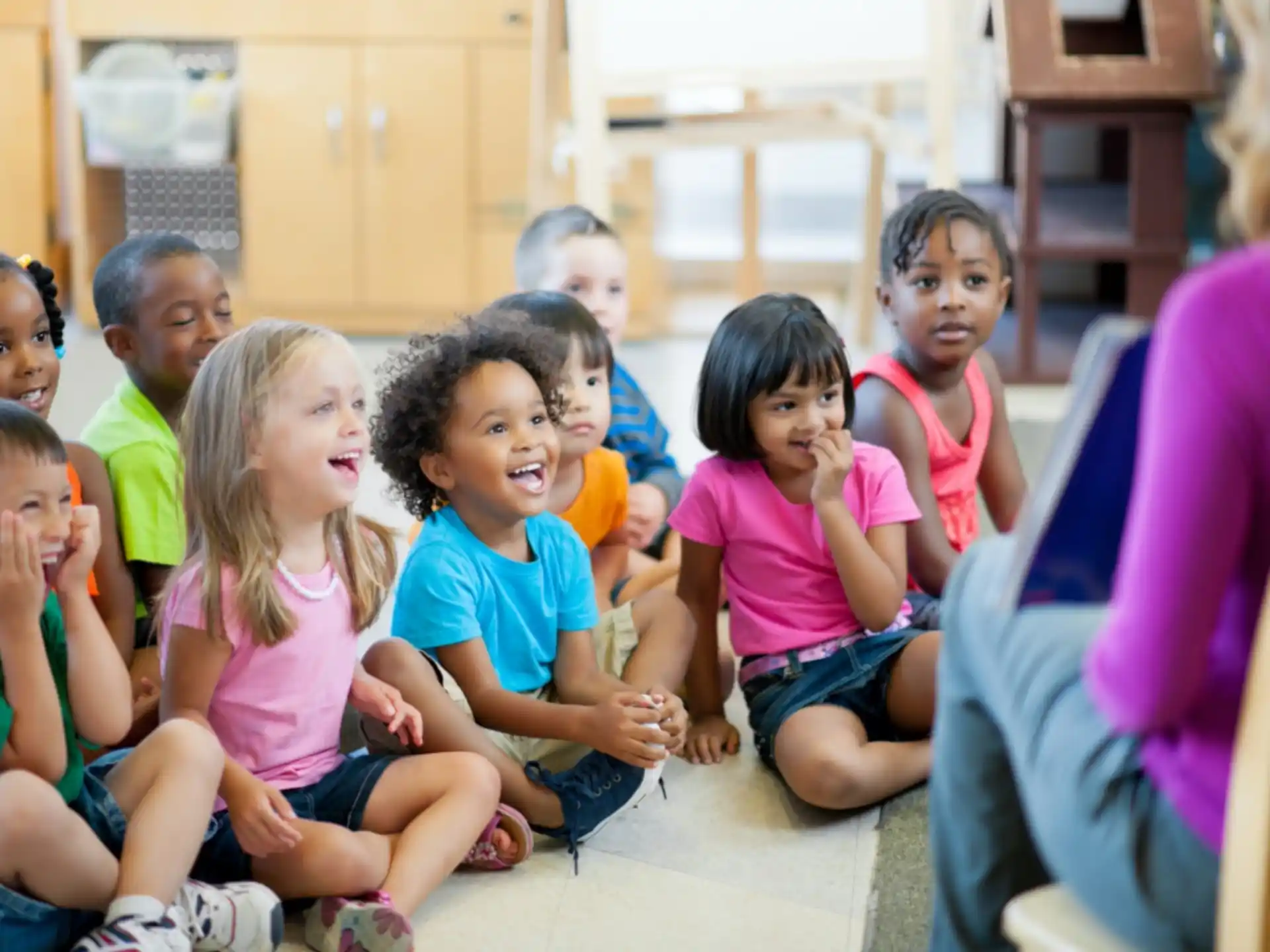 a group of children sitting in chairs