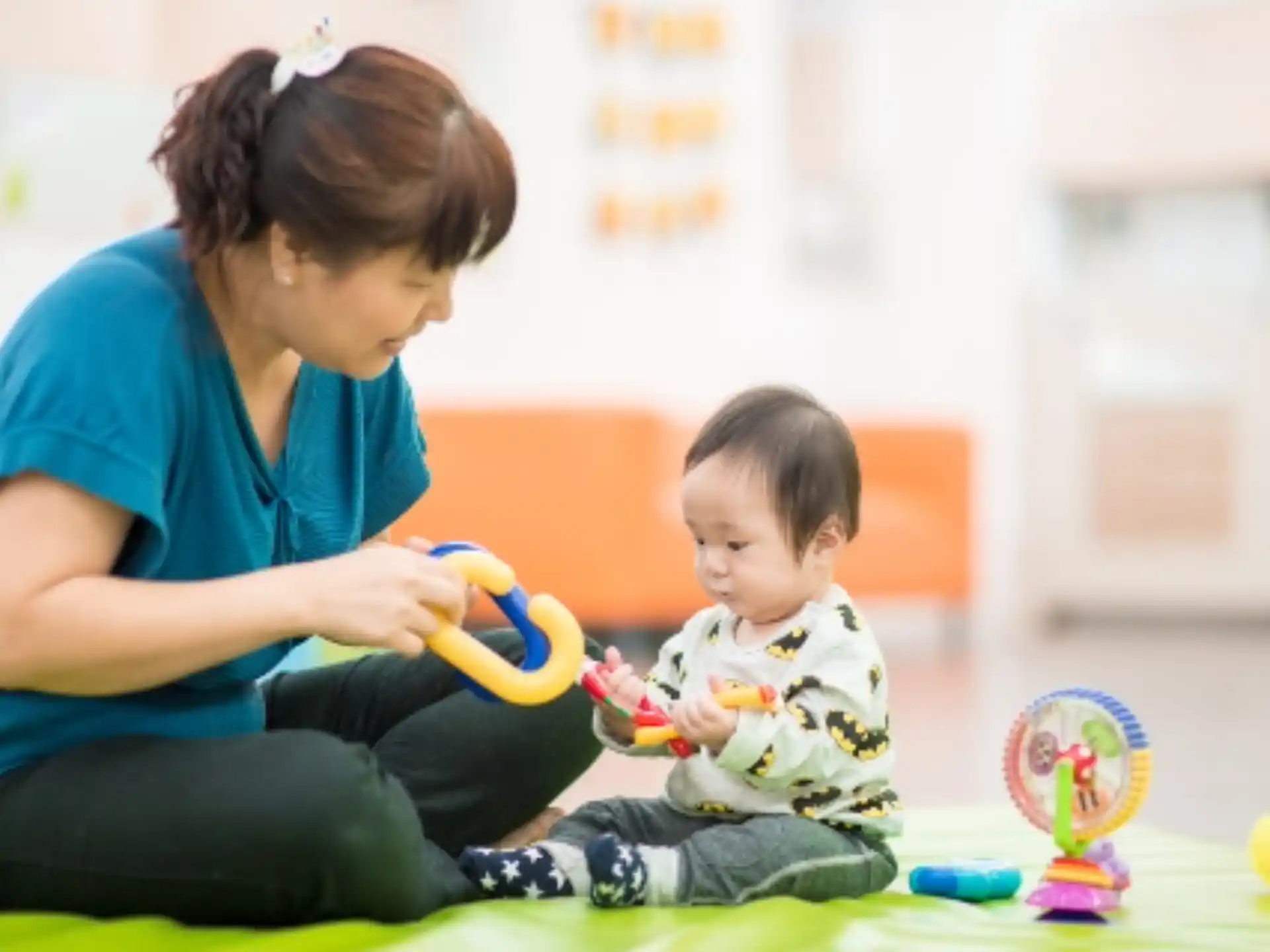 a person and a child playing with toys