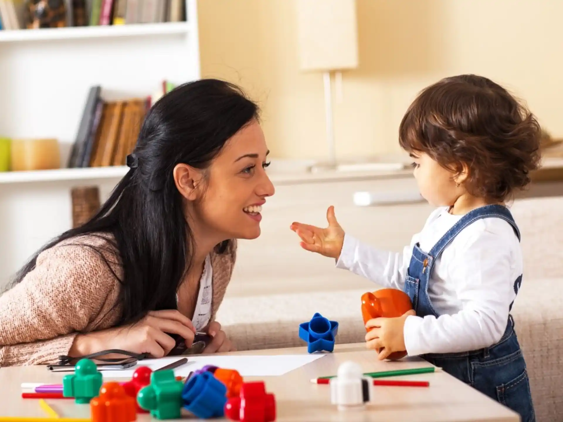 a woman and a child playing with toys