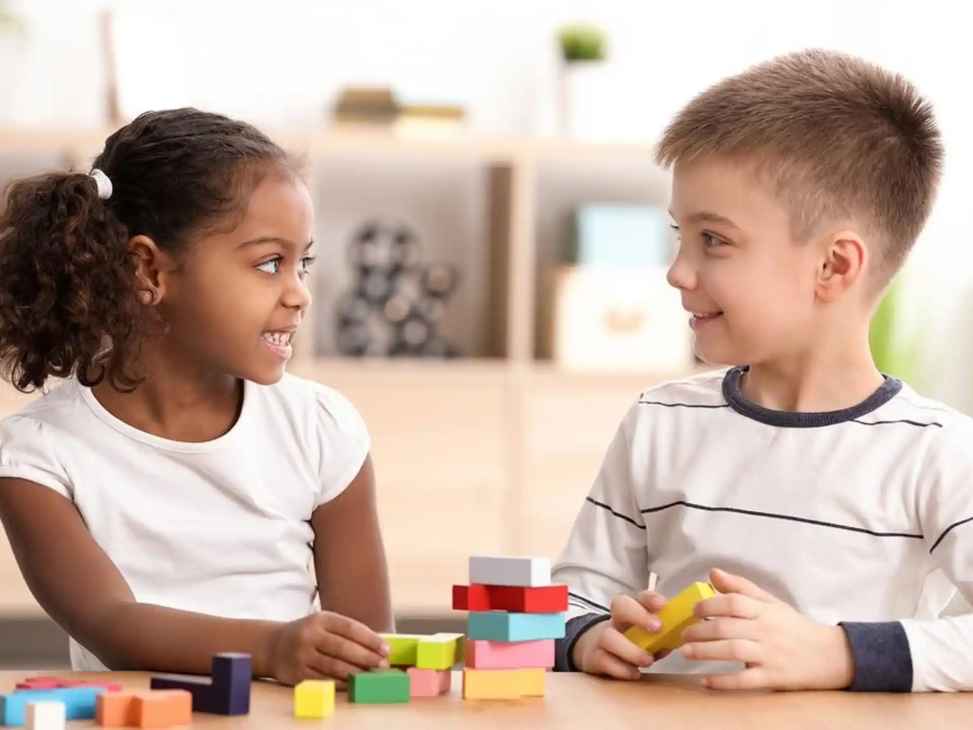 a couple of children playing with blocks