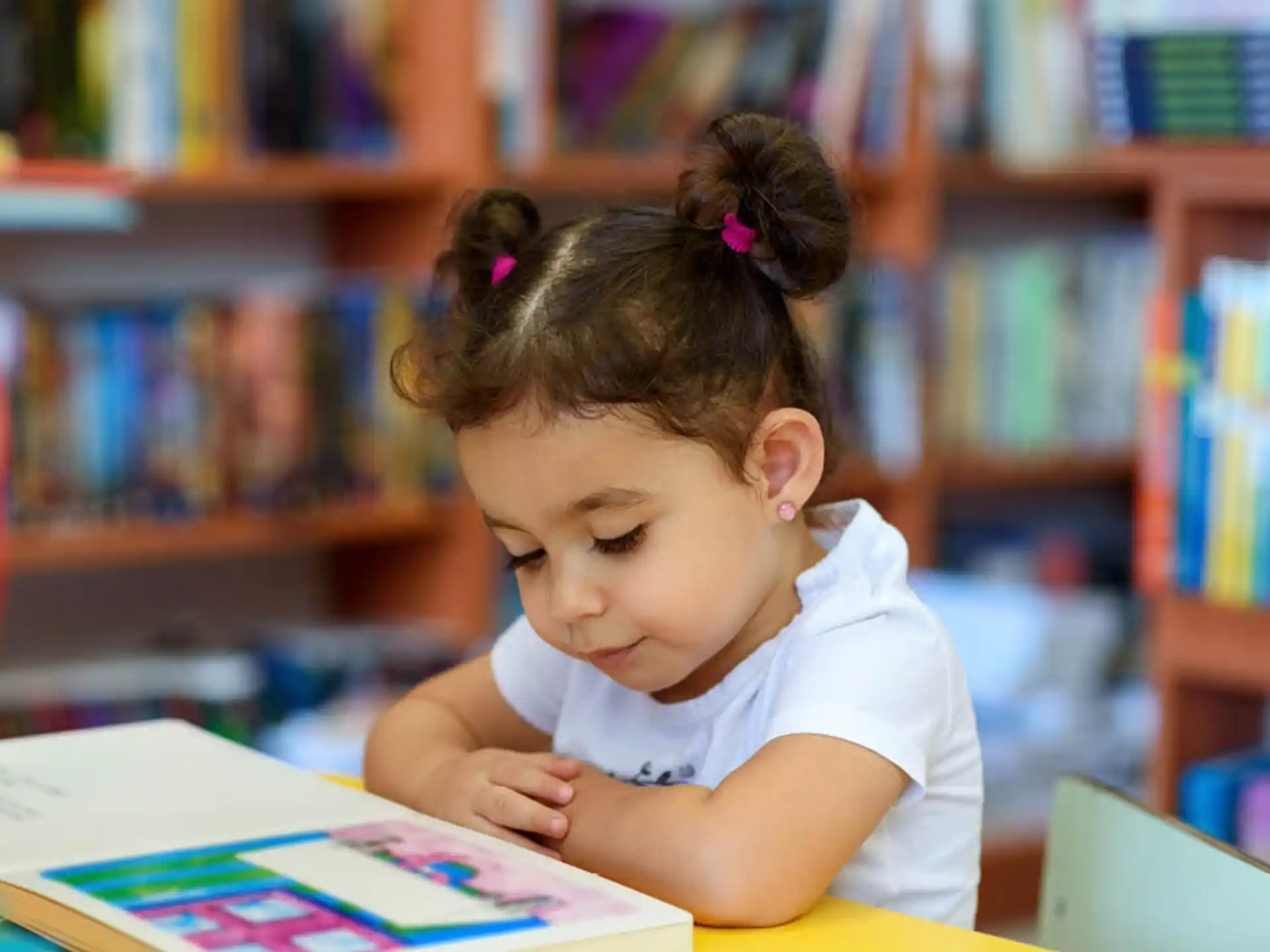 a young girl reading a book