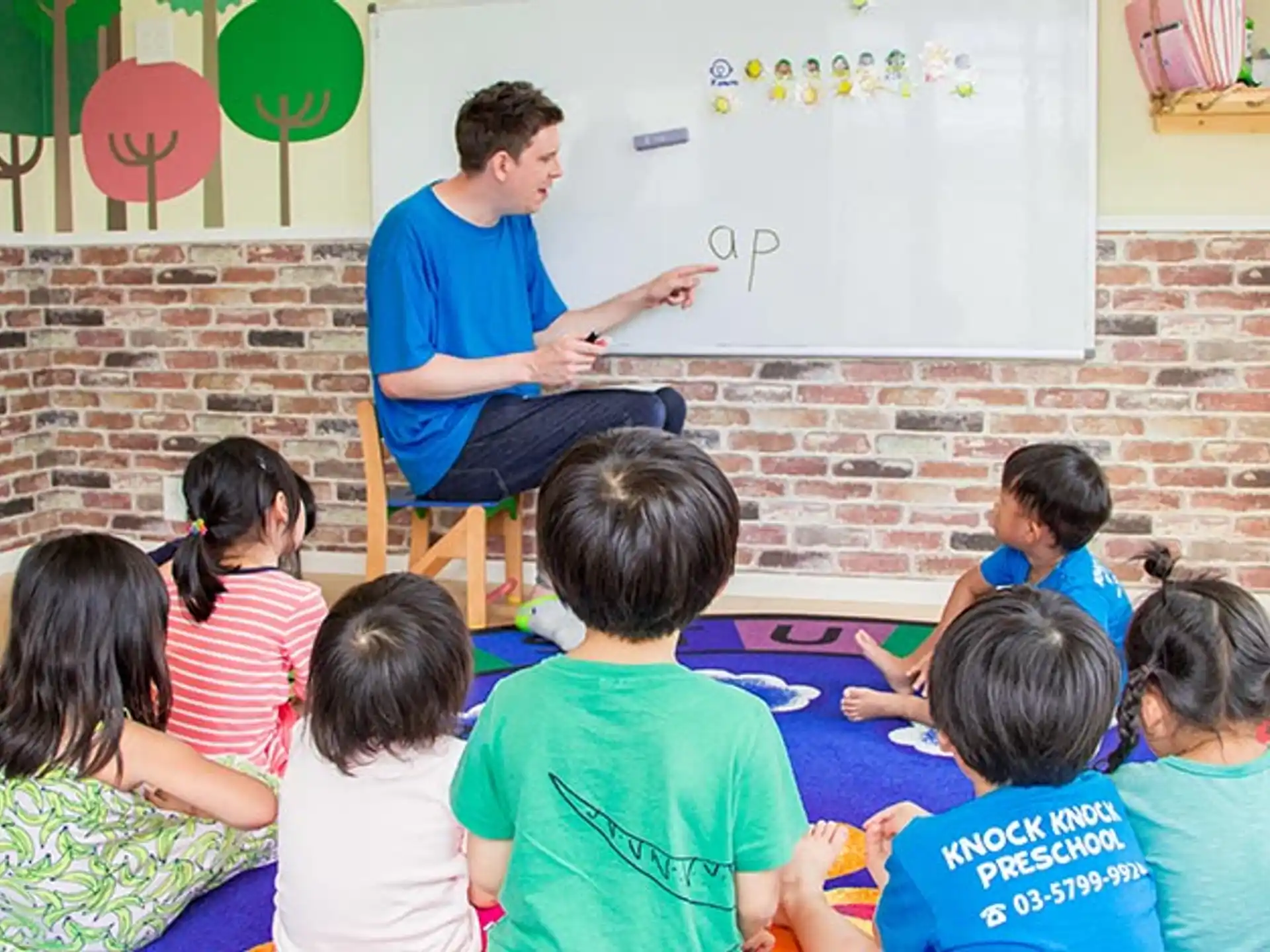 a man teaching children in a classroom
