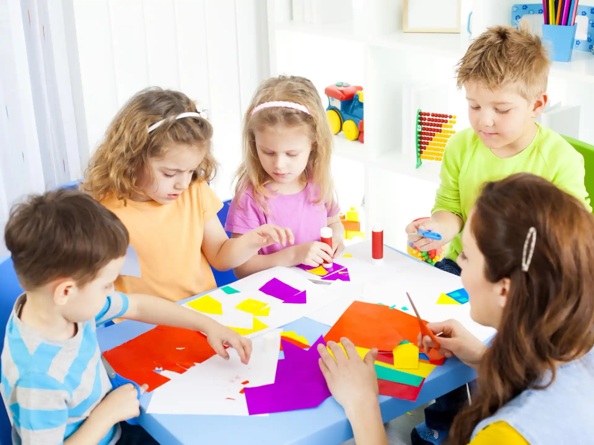 a group of children sitting around a table
