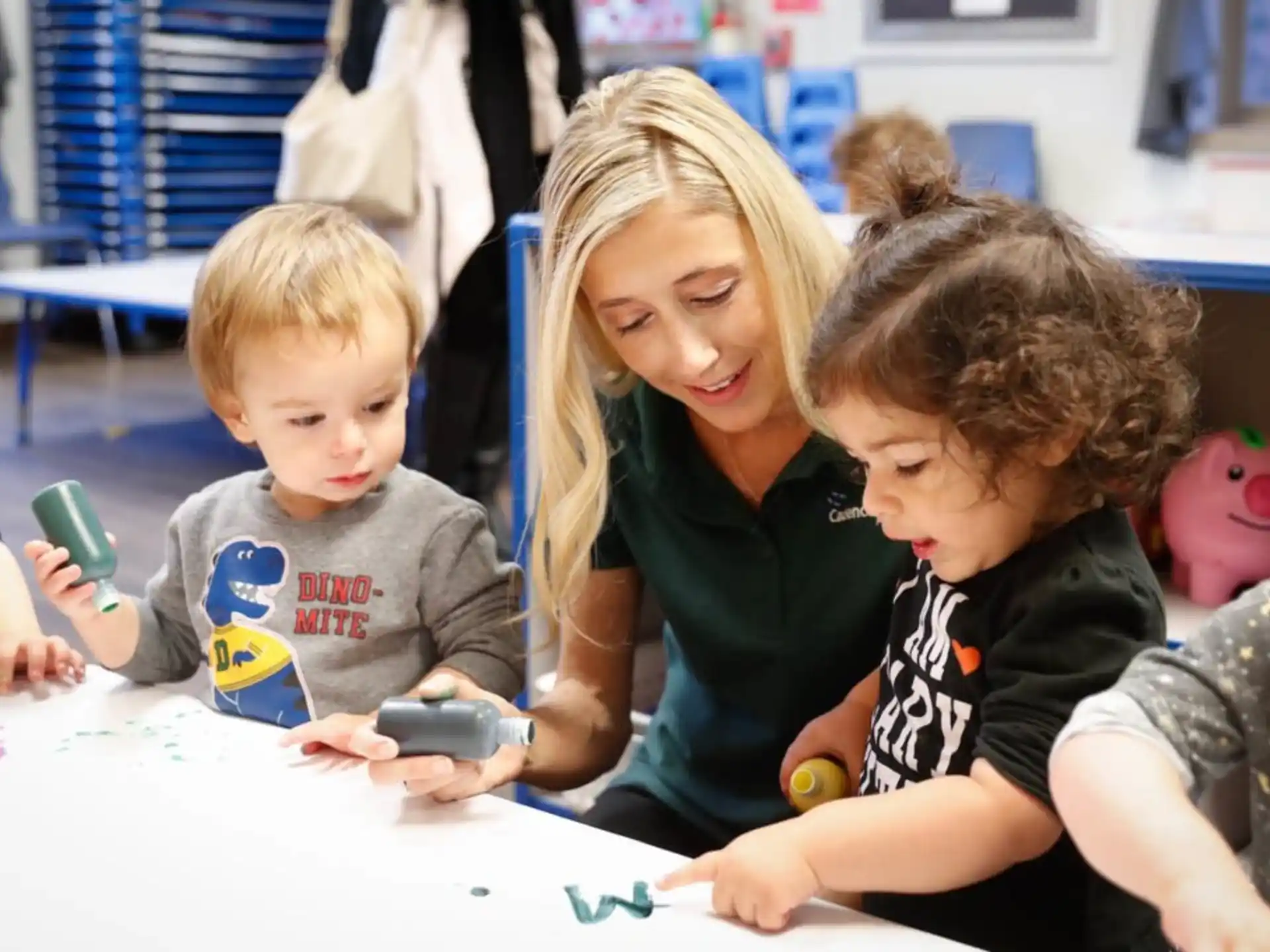a person and kids sitting at a table