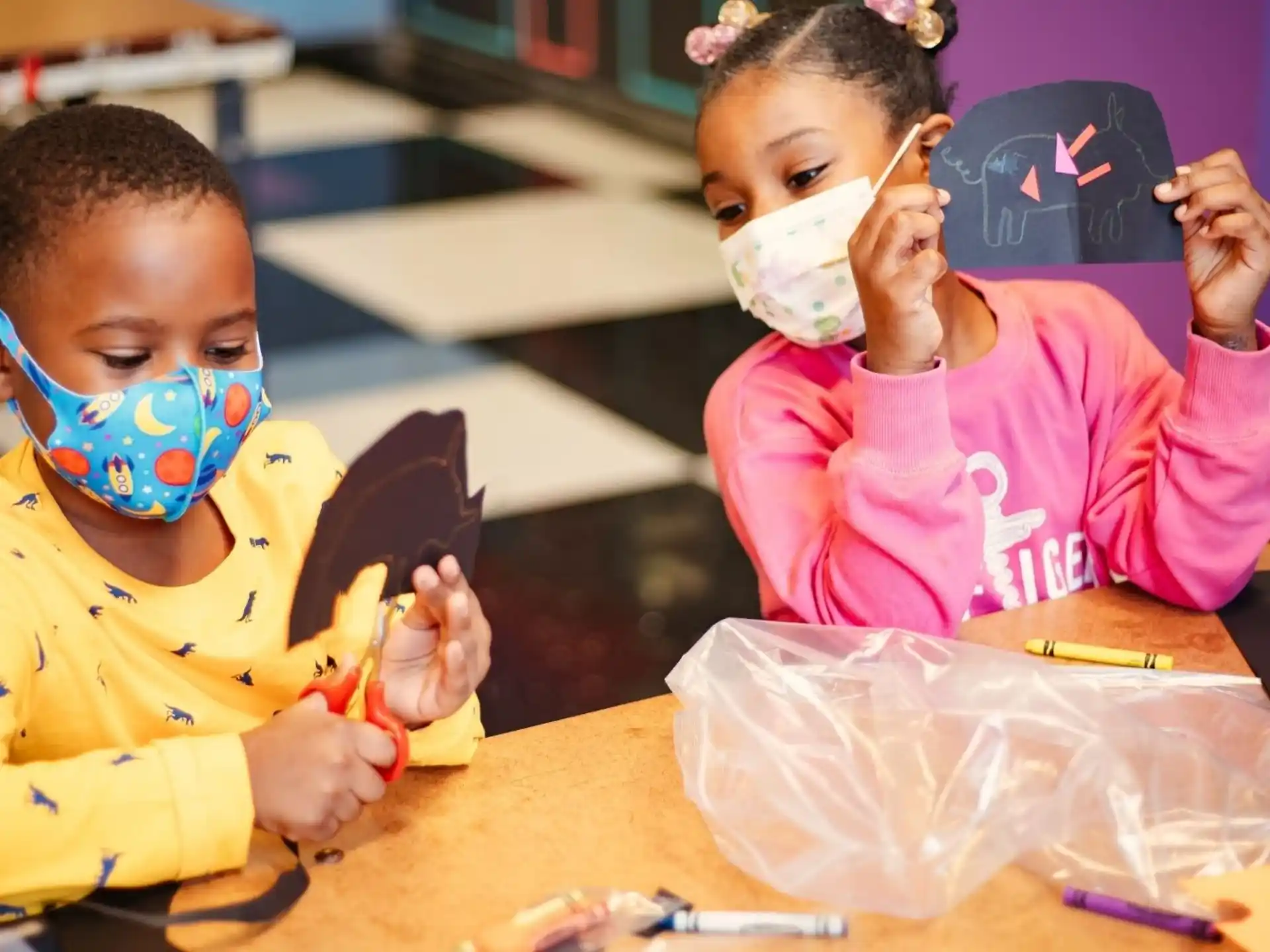 a couple of children painting