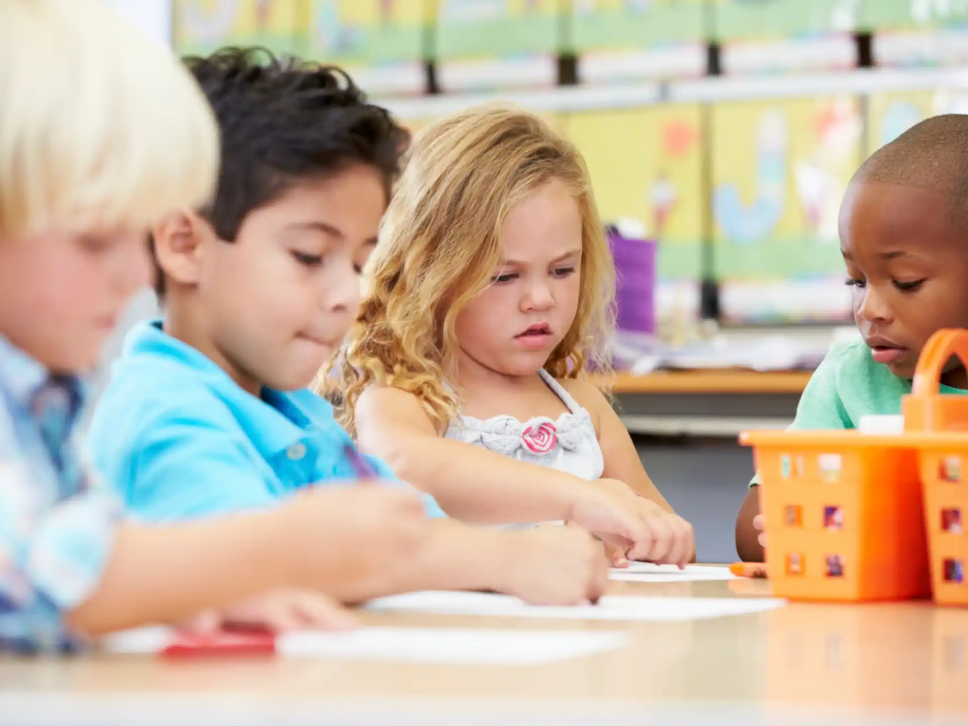 a group of children sitting at a table