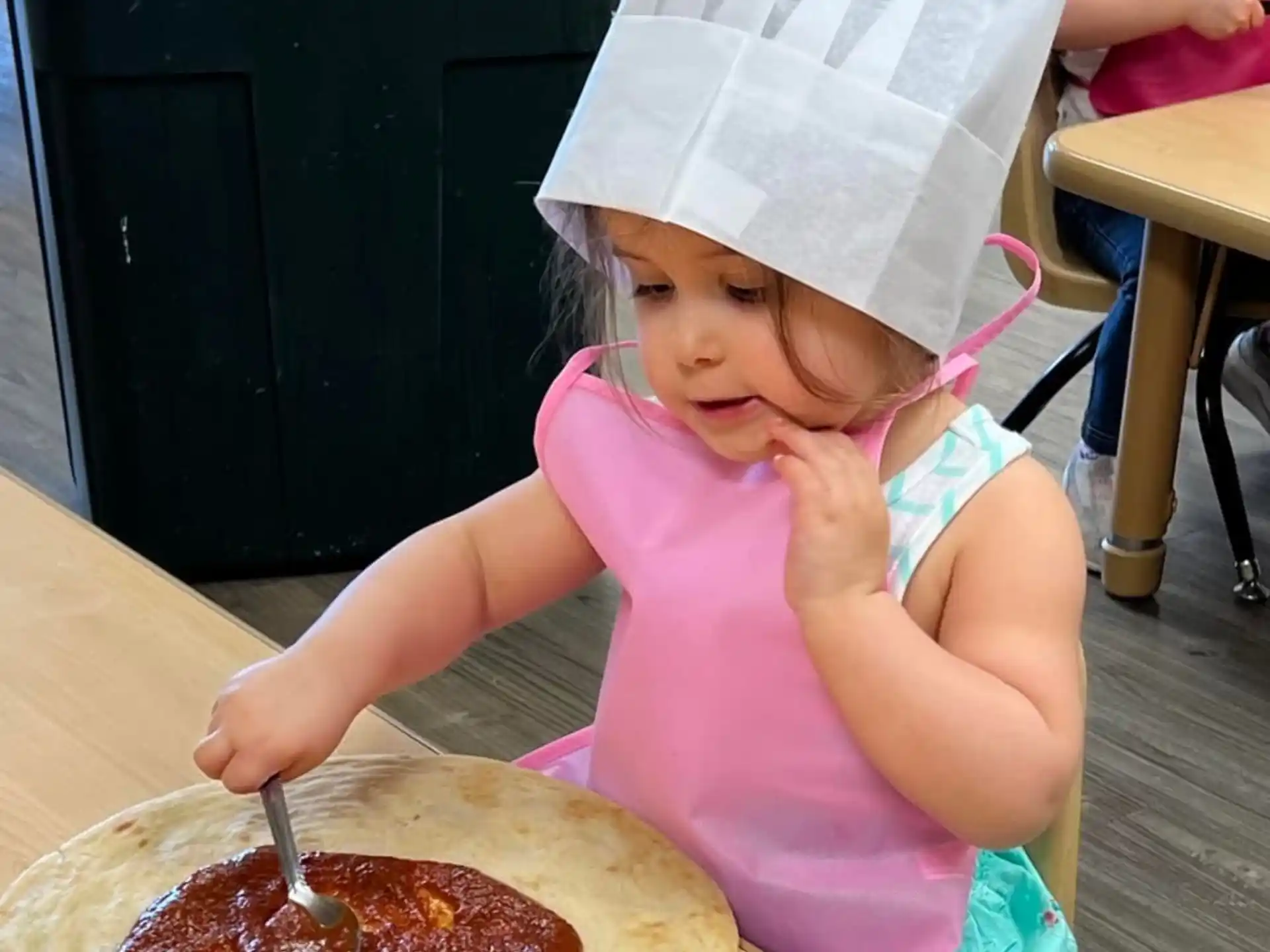 a little girl eating pizza