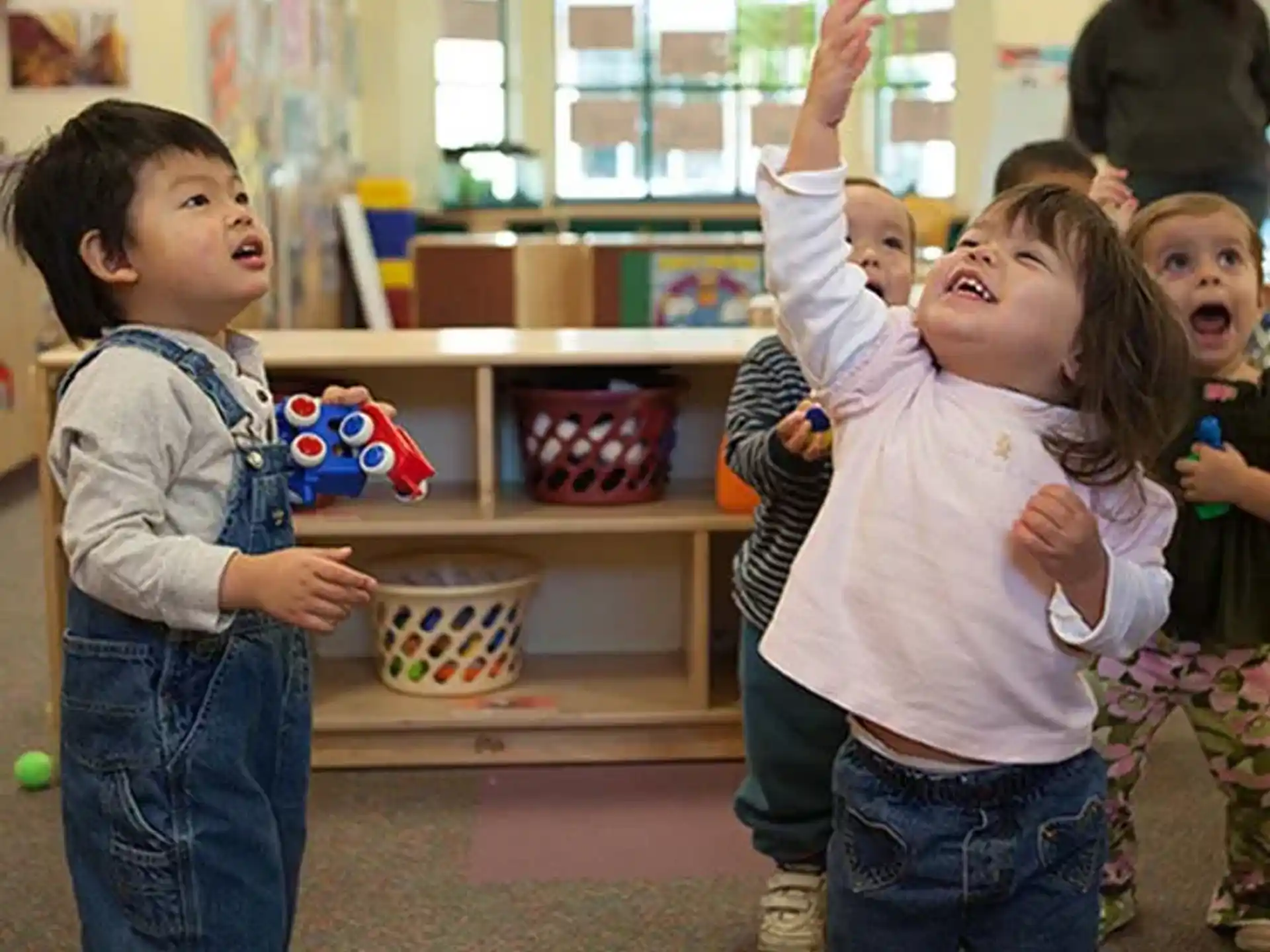 a group of children playing with toys