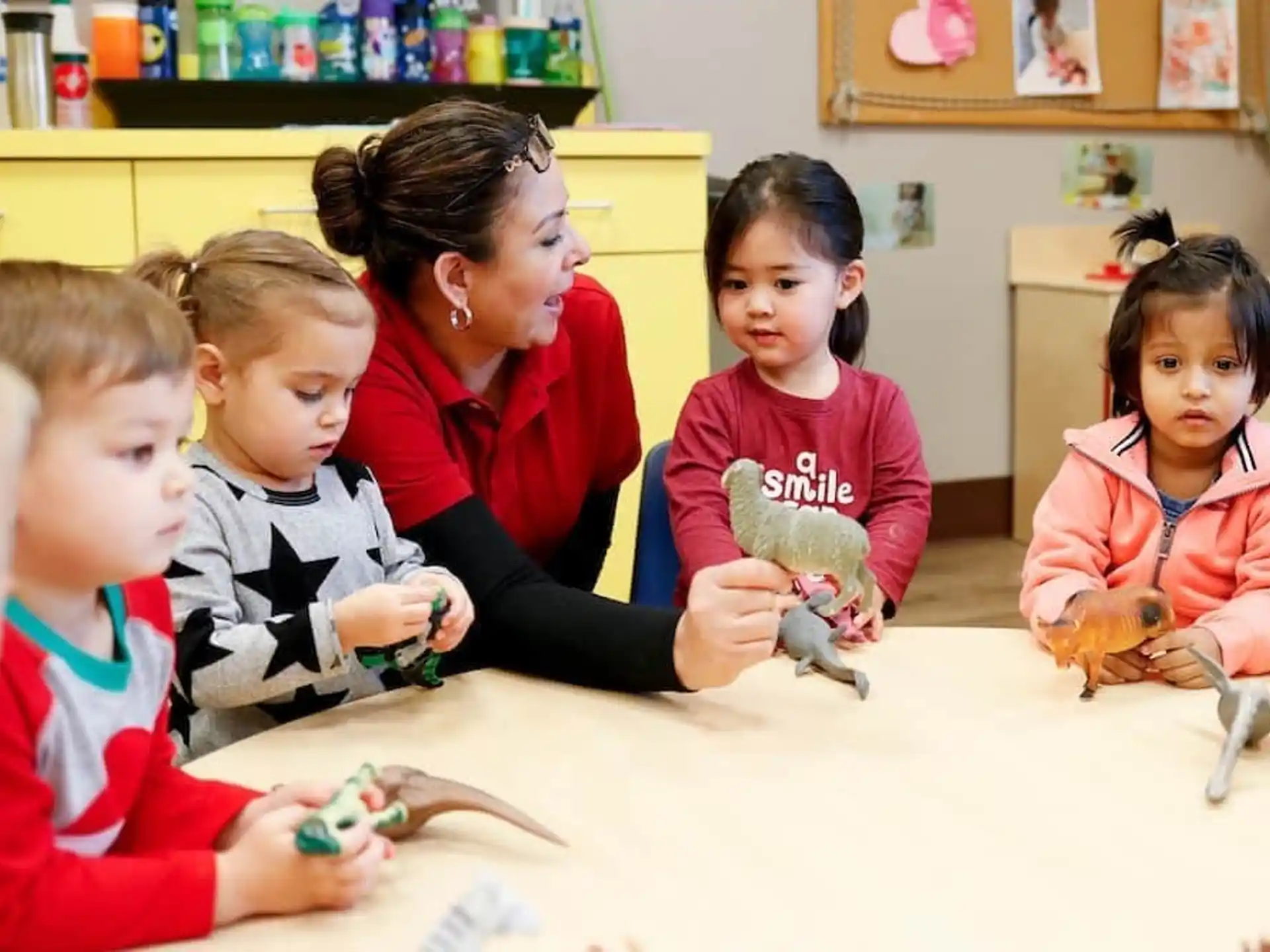 a person and several children playing with toys