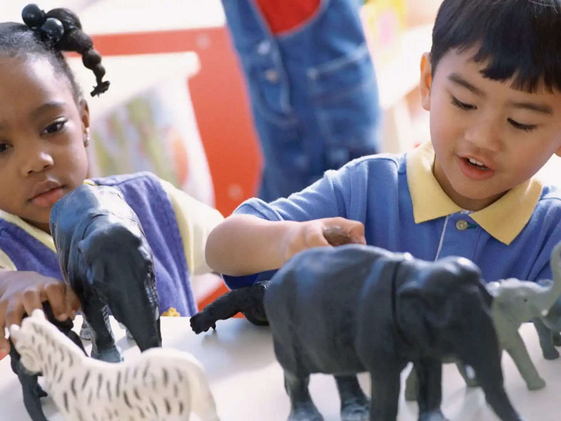 a couple of young children playing with toys