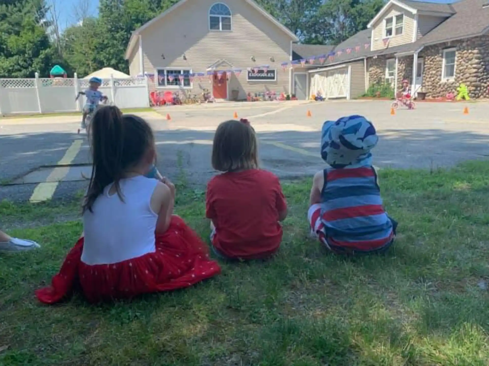 a group of children sitting on the grass