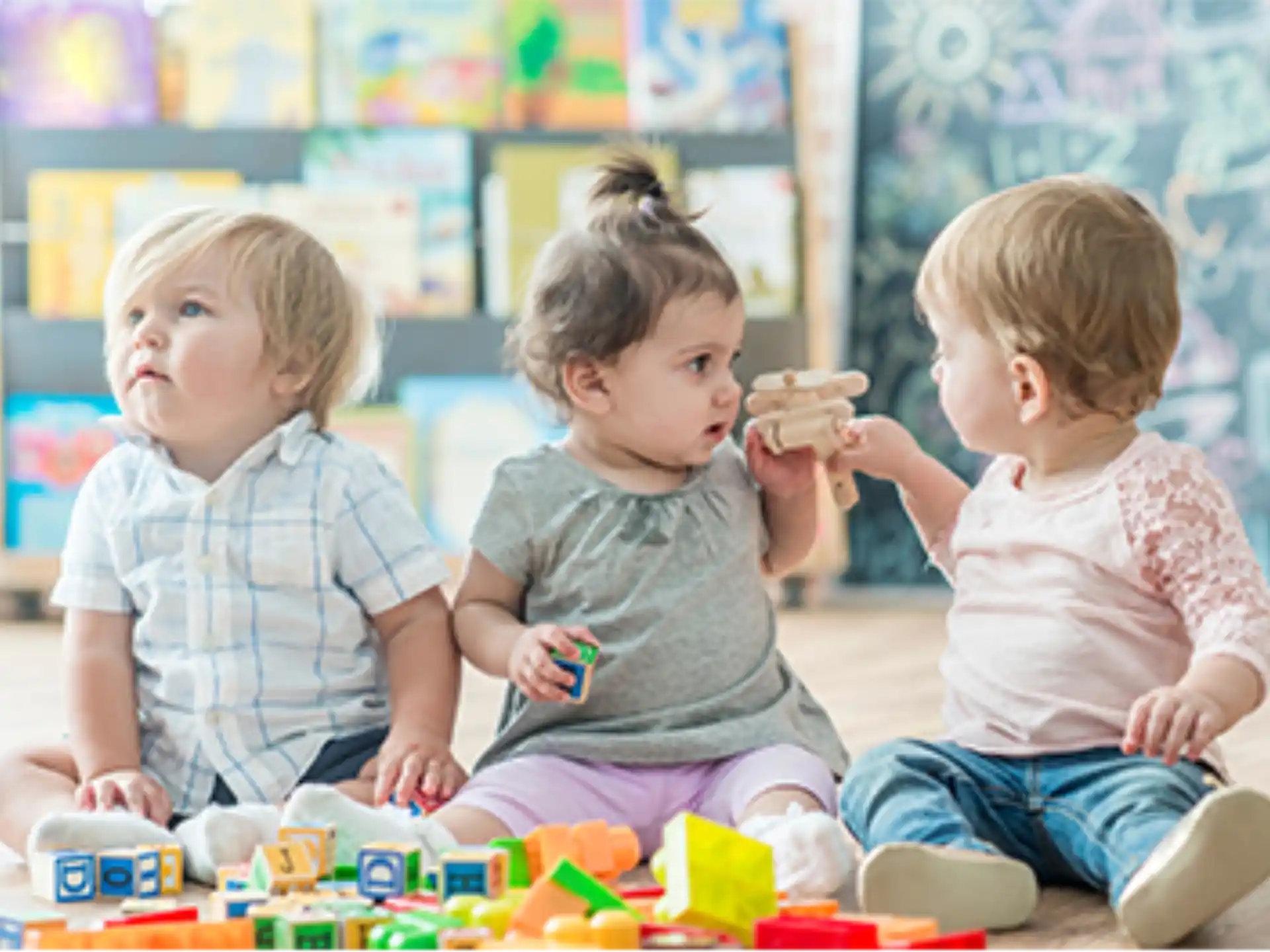 a group of children sitting on the floor eating