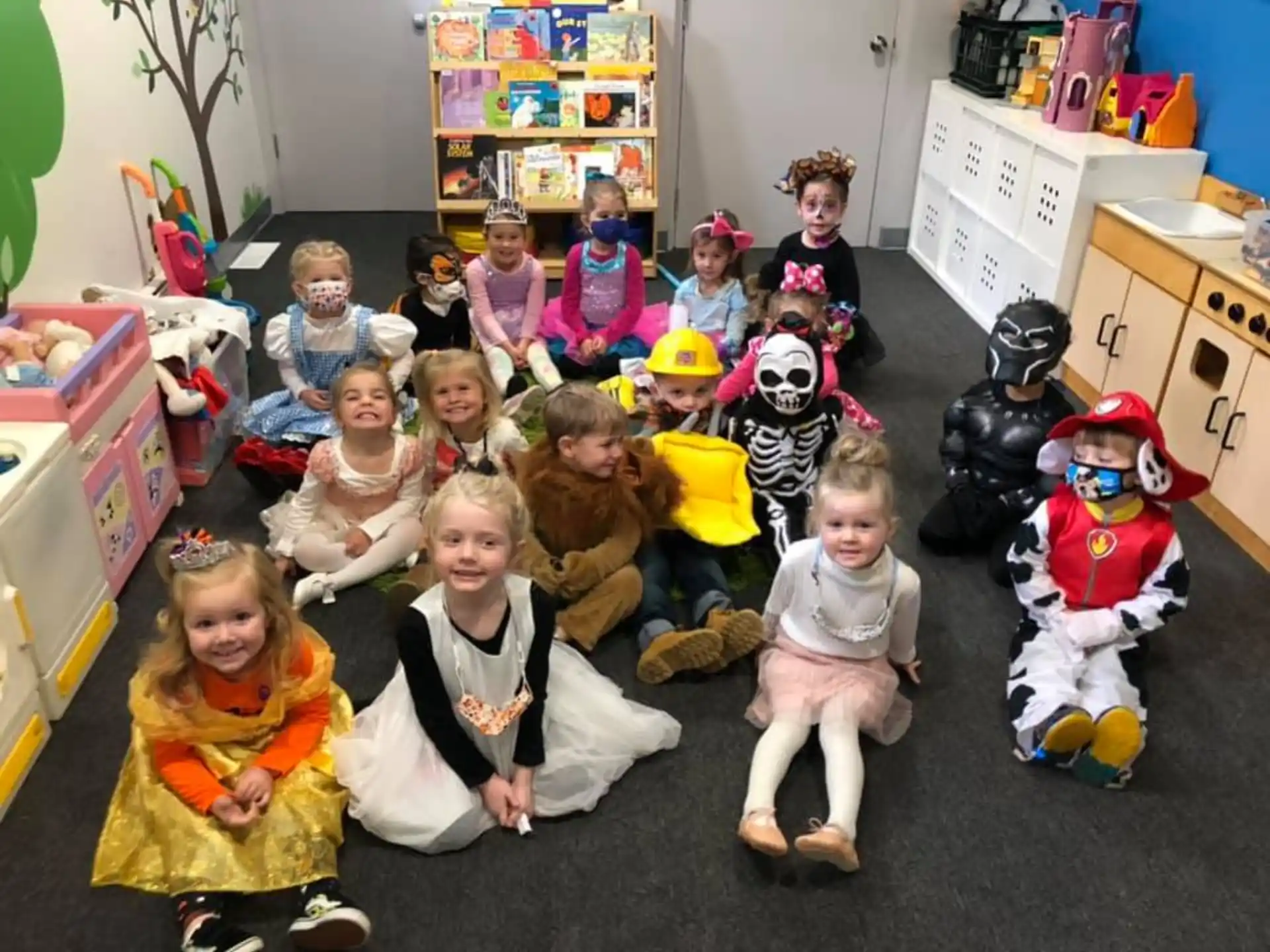a group of children sitting on the floor in a room