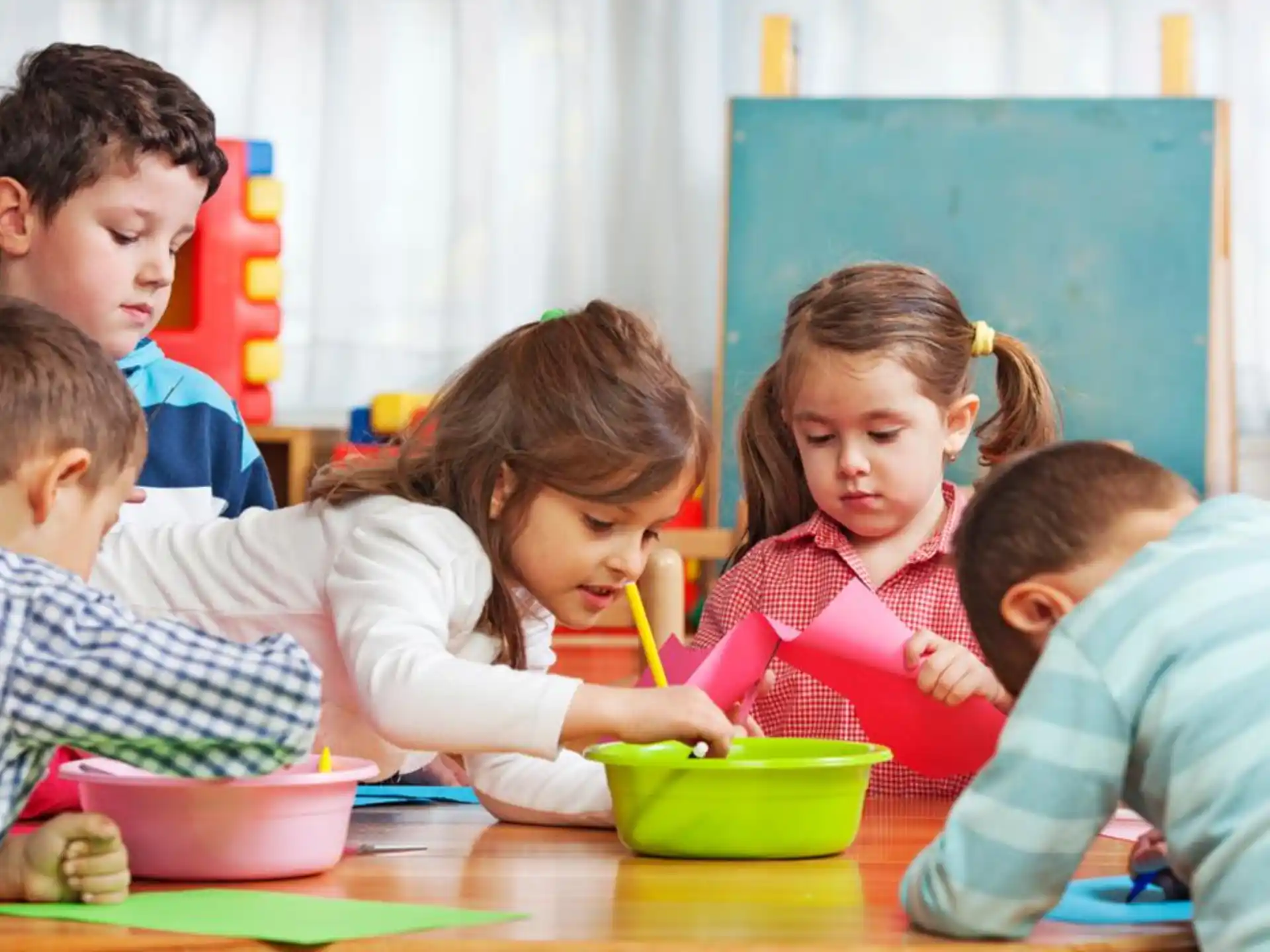 a group of children sitting at a table