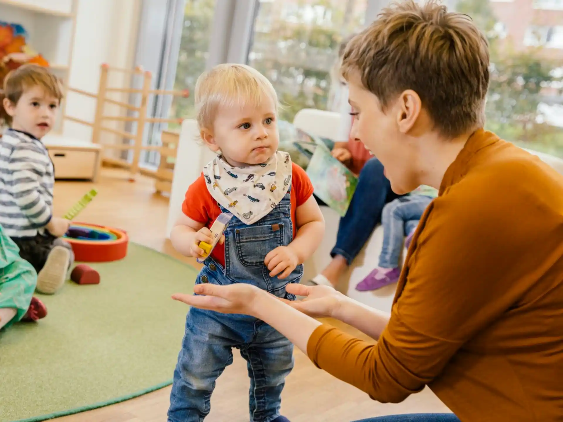 a person and a couple of children playing with toys