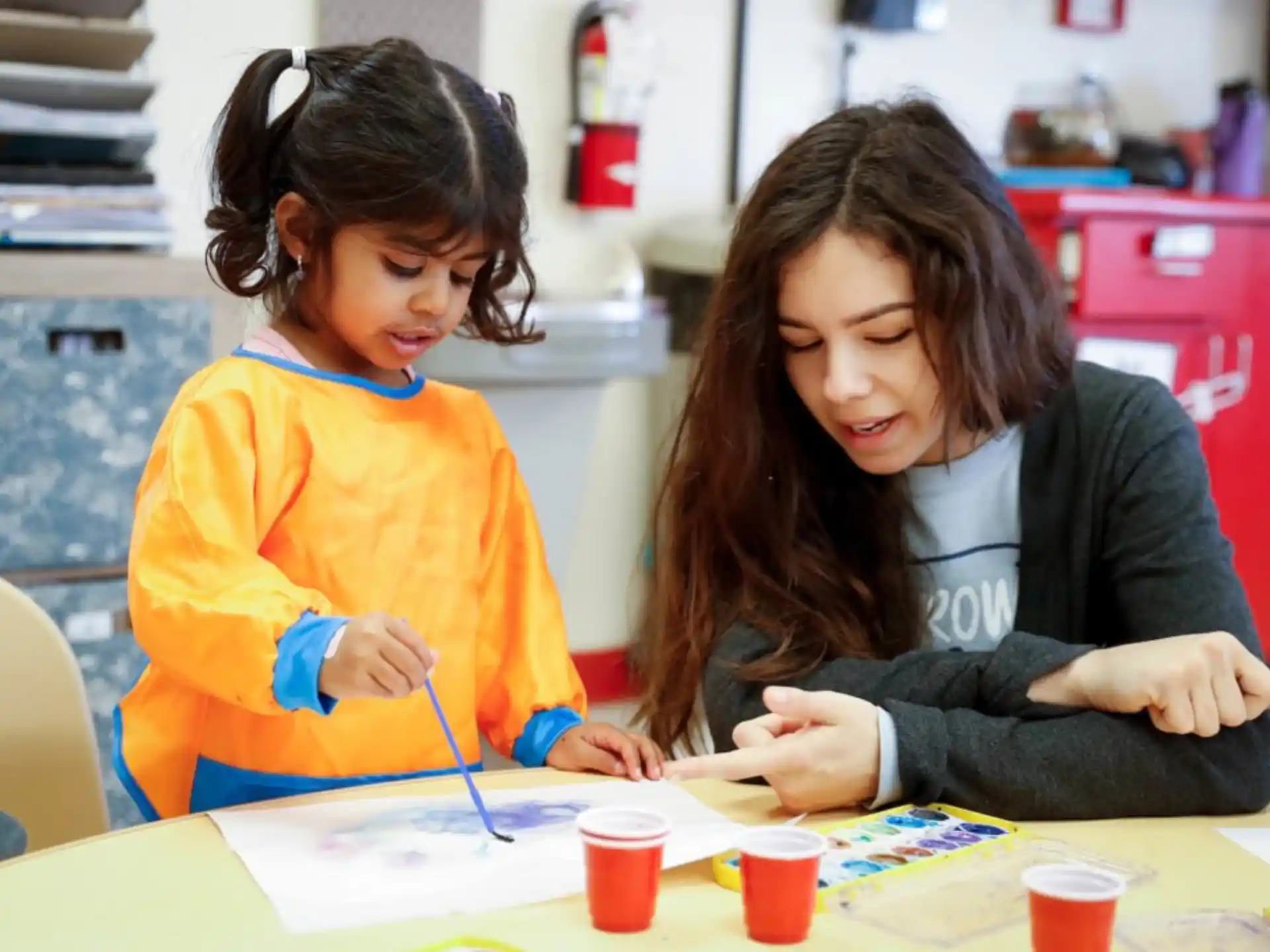 a woman and a child painting