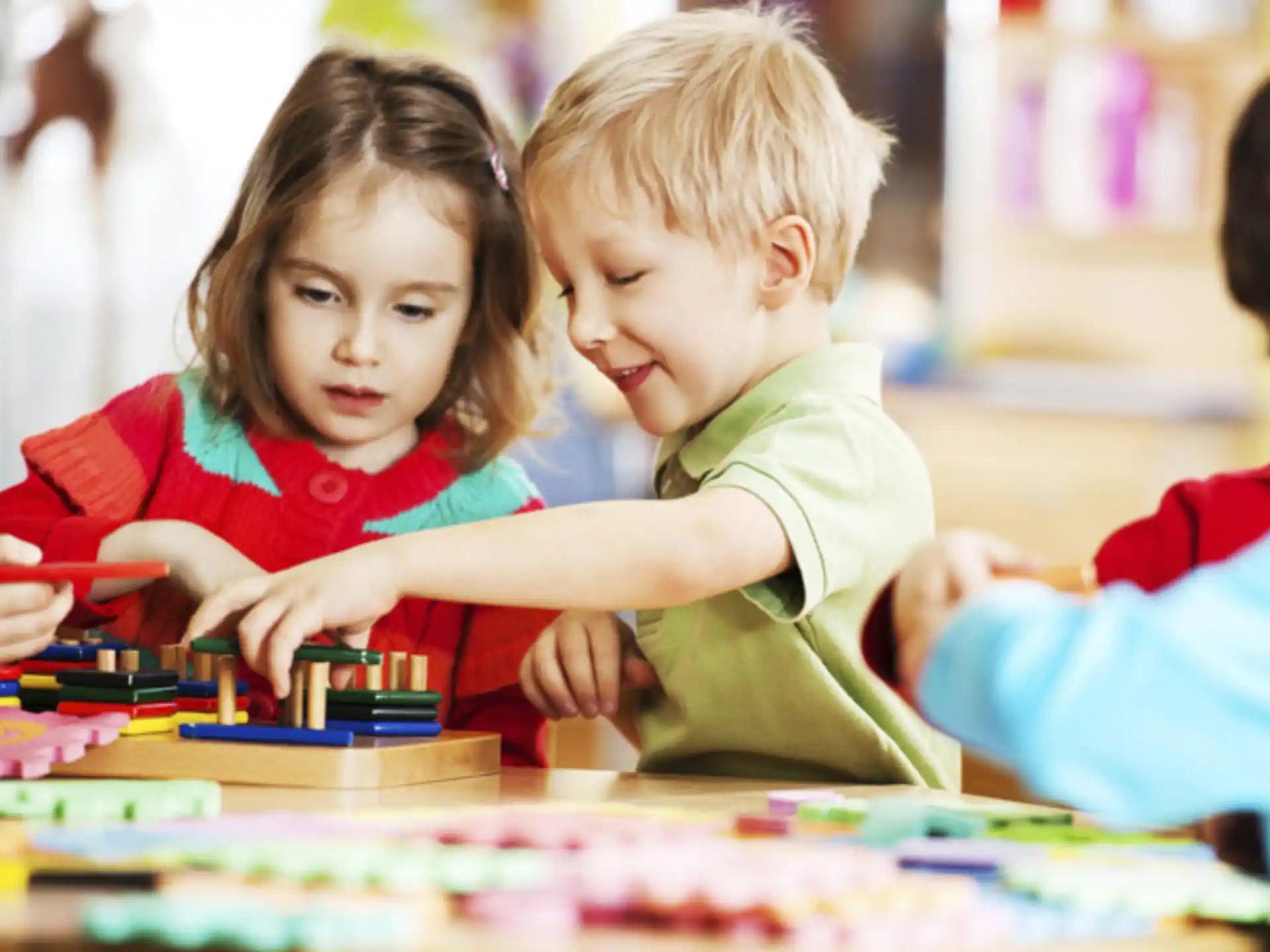 a couple of children playing with a toy