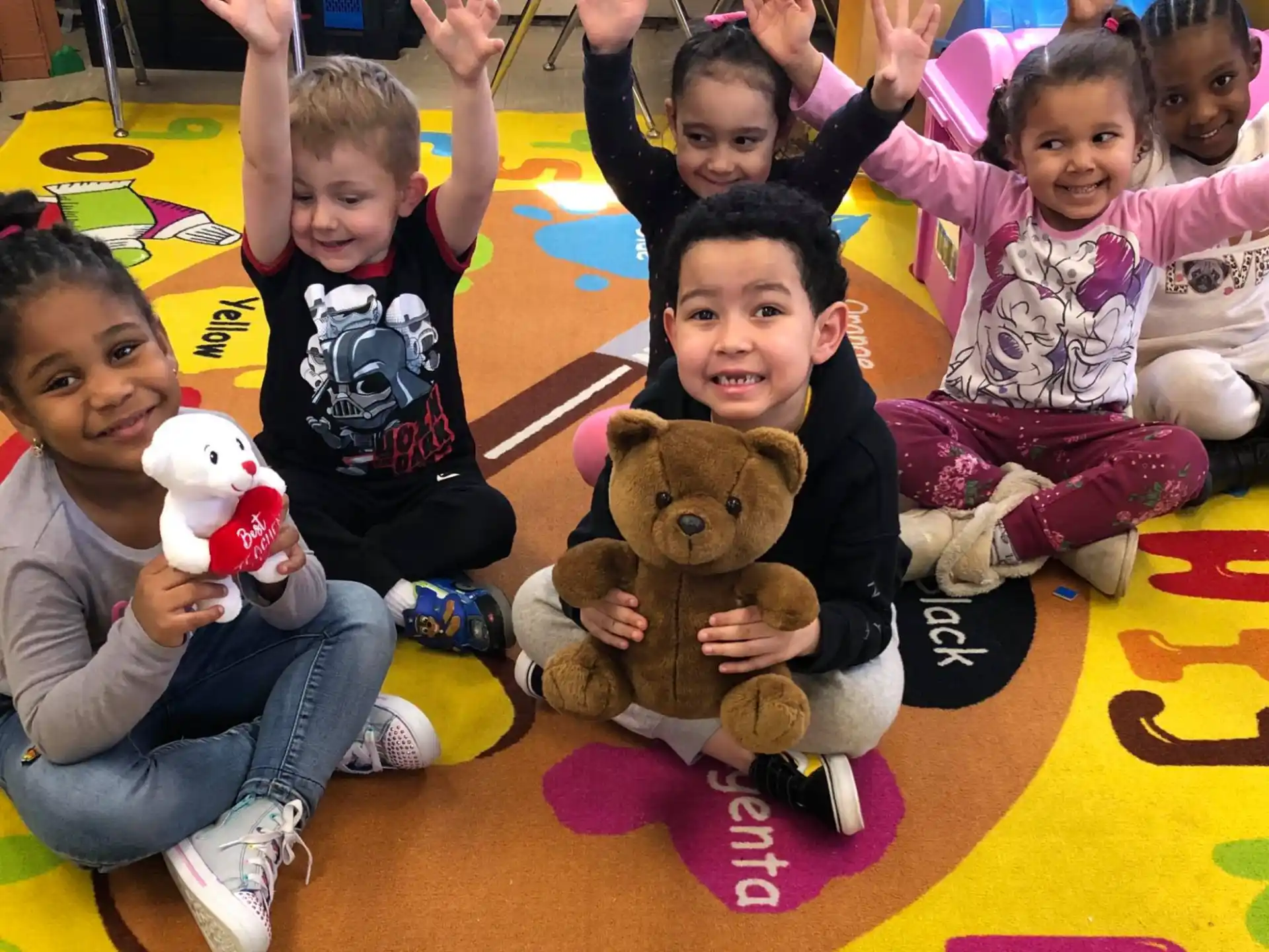 a group of children holding stuffed animals