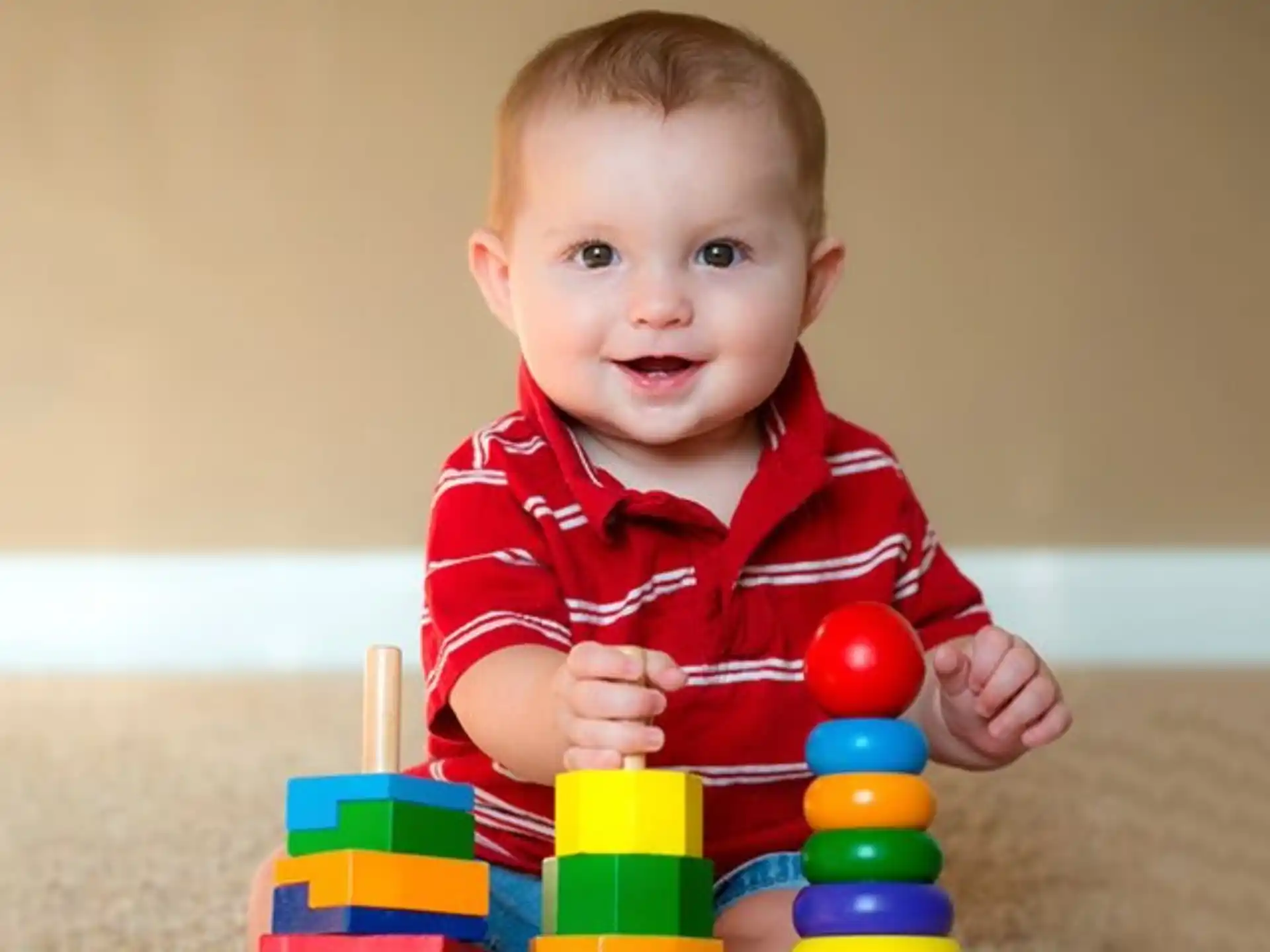 a baby sitting on a toy