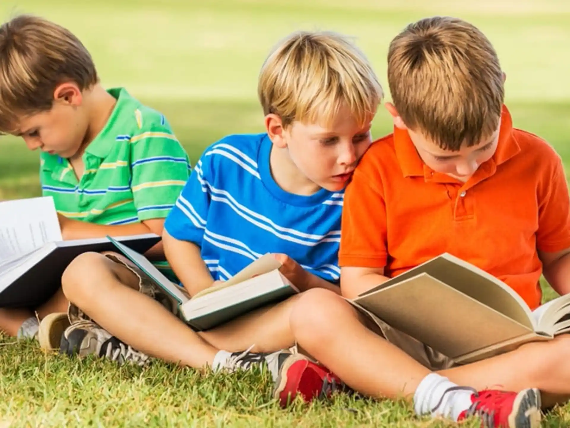 a group of boys reading books