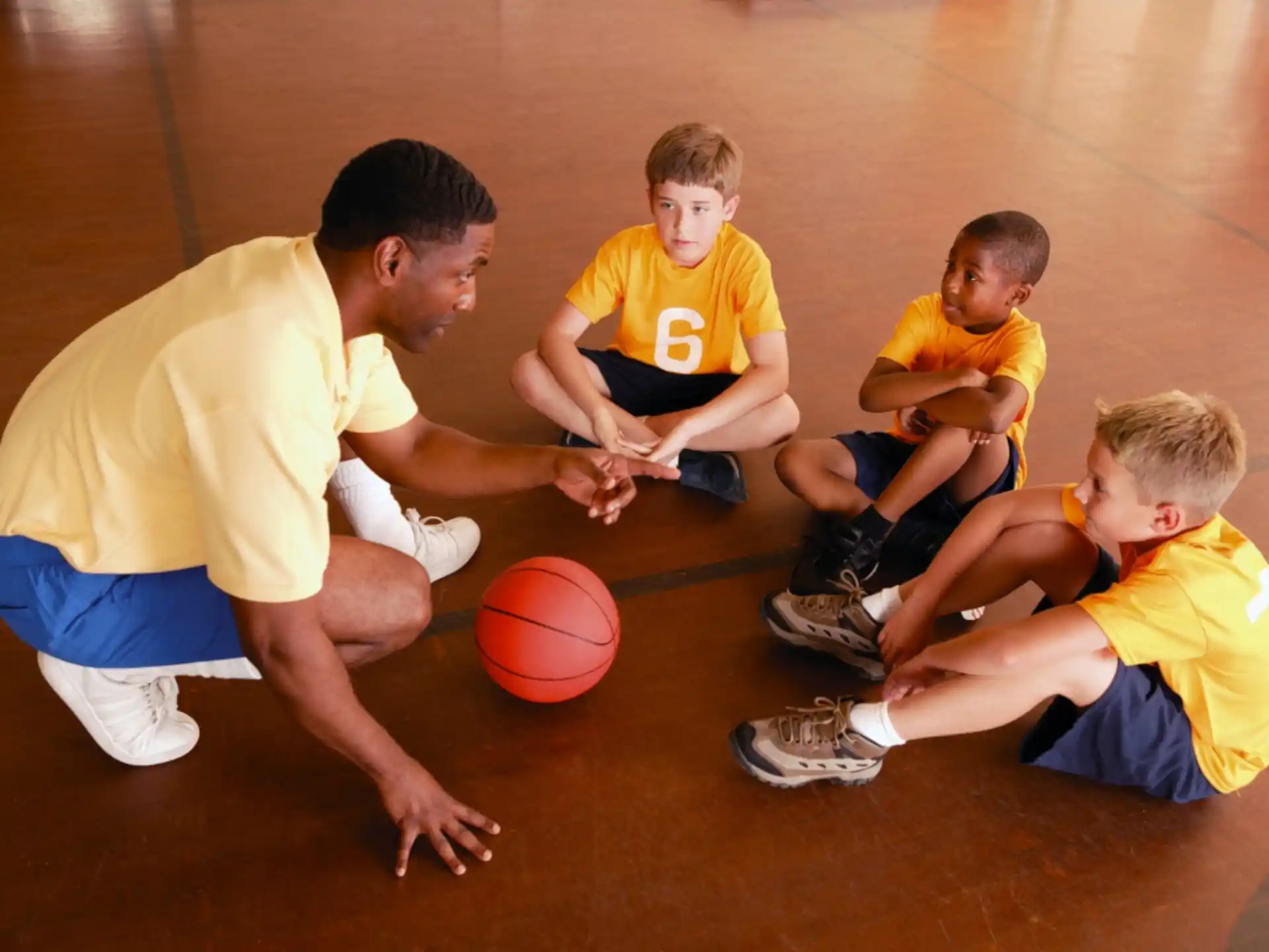 a group of boys playing basketball