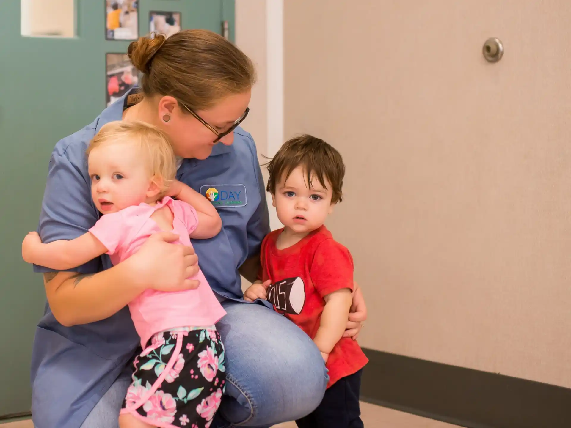 a person holding two children
