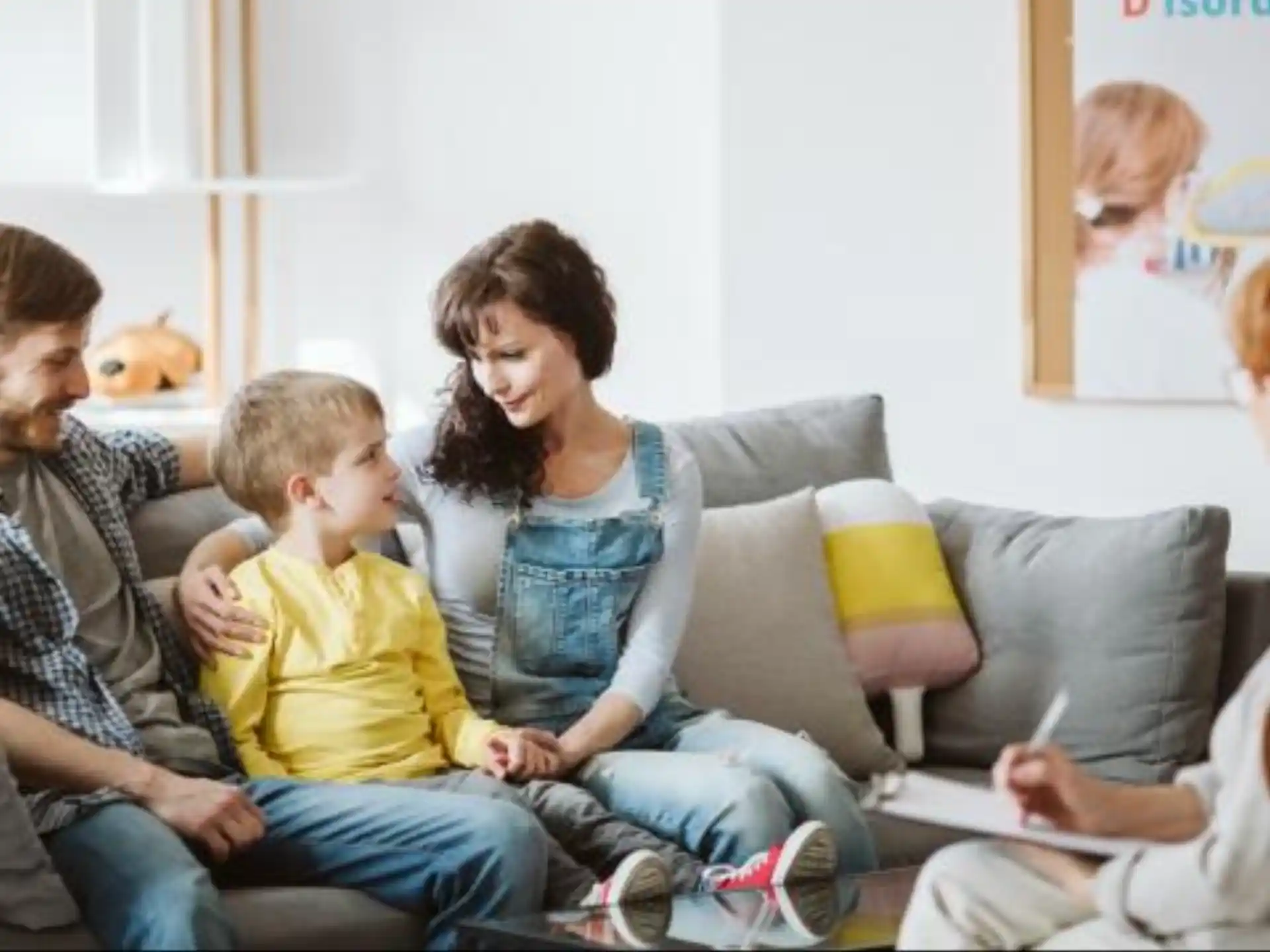 a family sitting on a couch