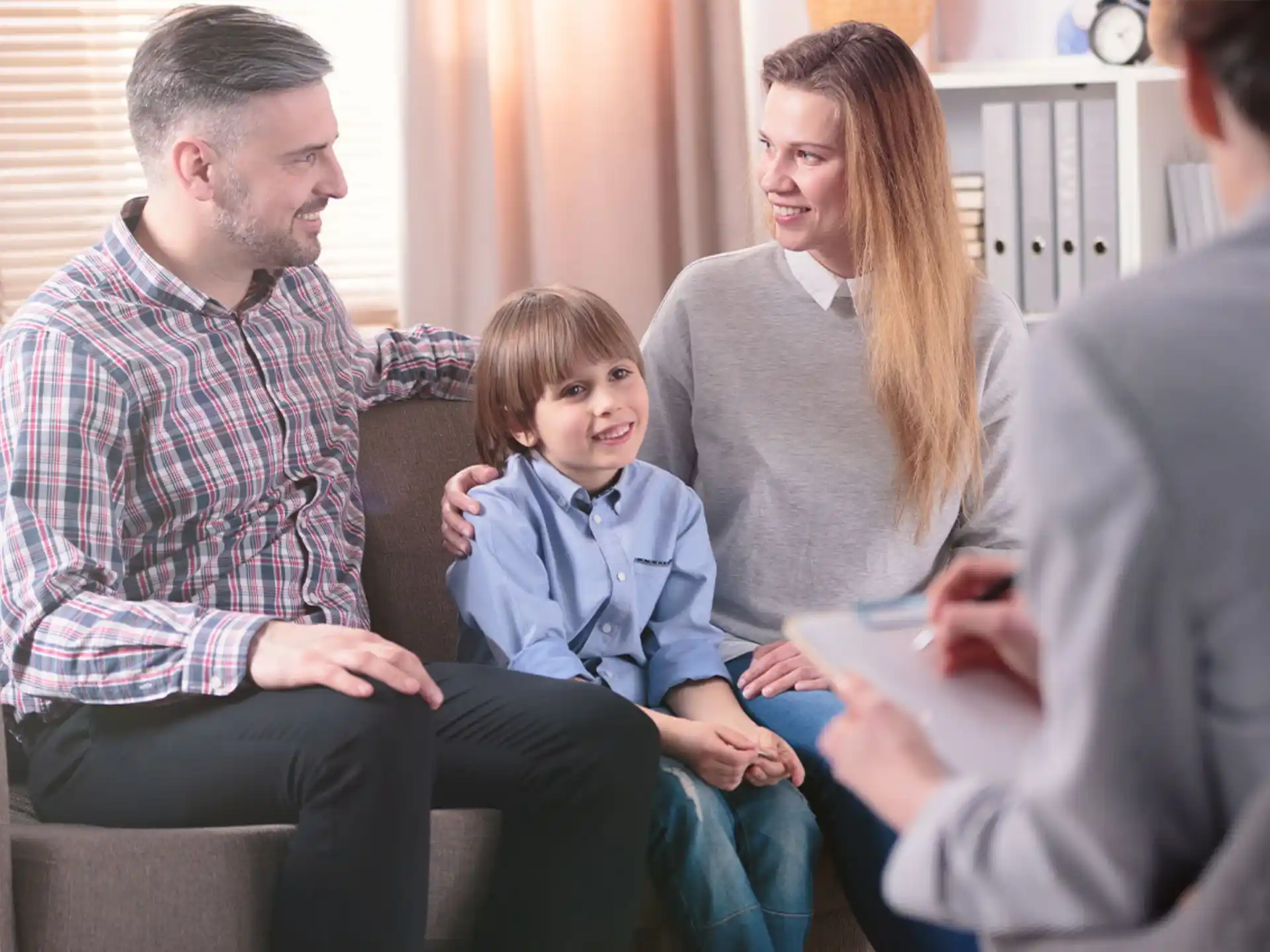 a family sitting on a couch