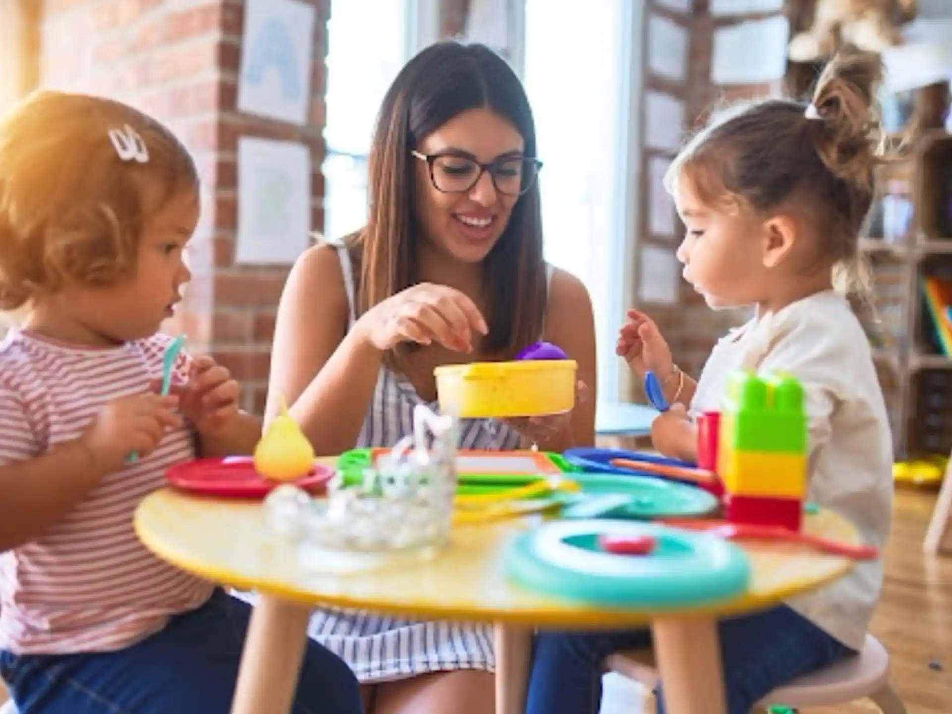 a person and two children sitting at a table