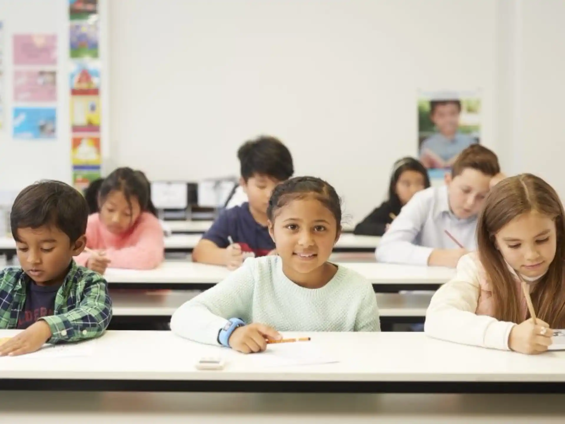 a group of children sitting at desks in a classroom