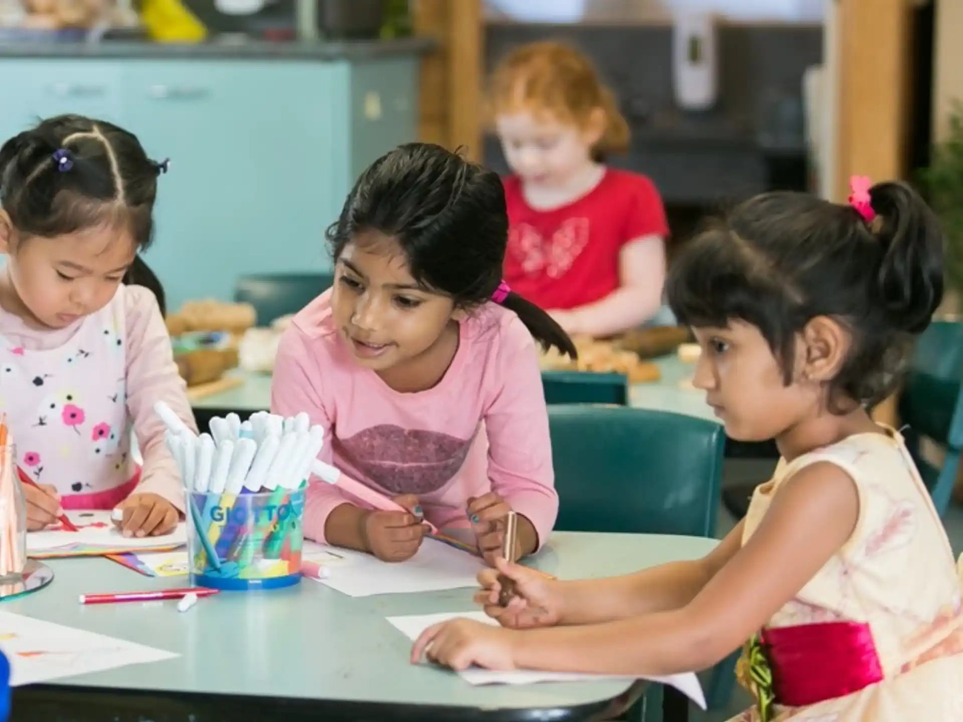 a group of children sitting at a table