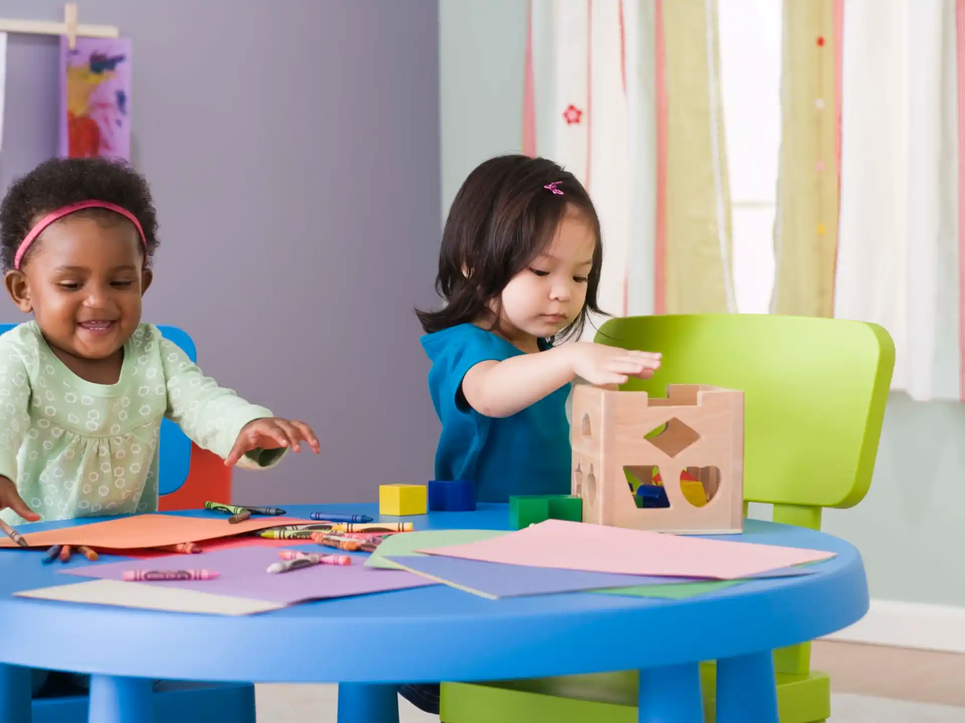 a couple of girls playing with a toy