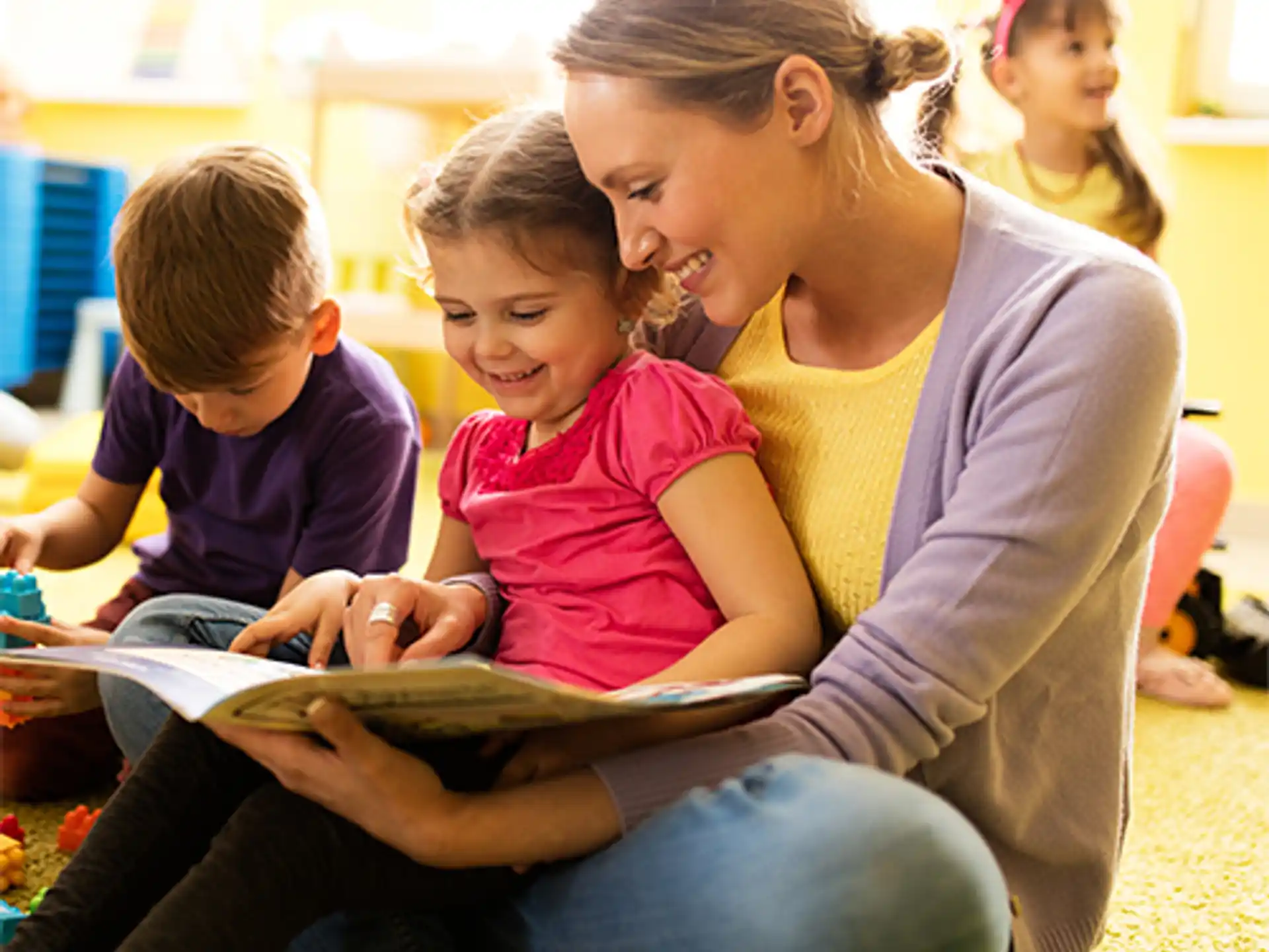 a group of children sitting on the floor reading books