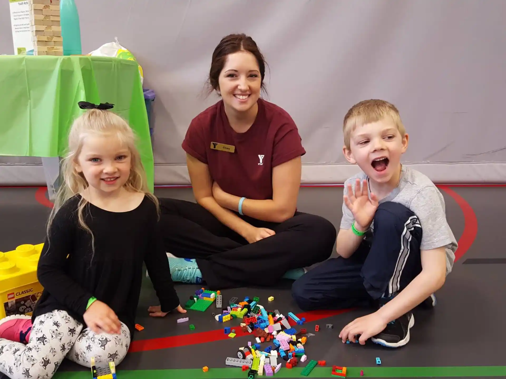 a group of people sitting on the floor with toys