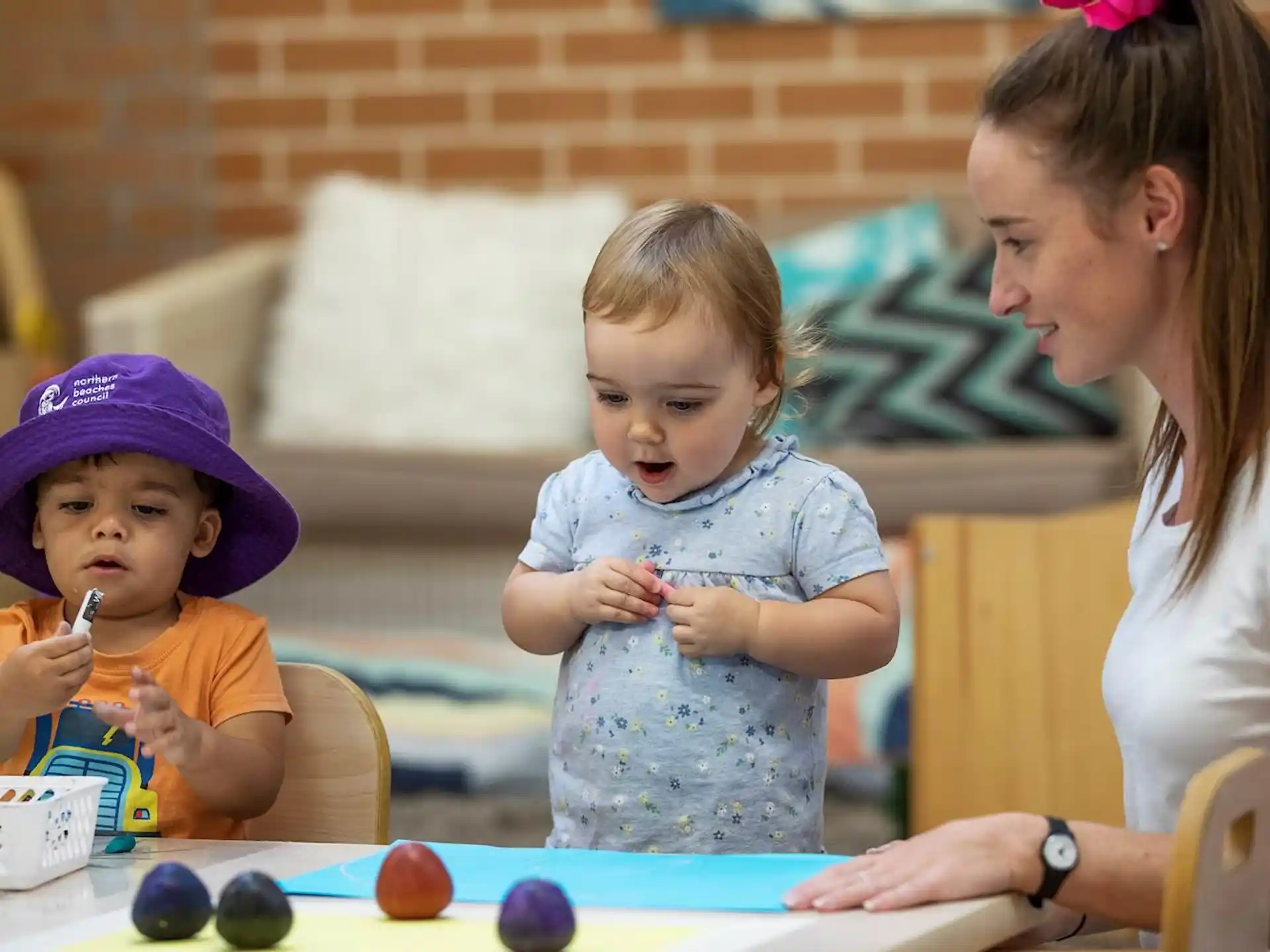 a person and two children eating