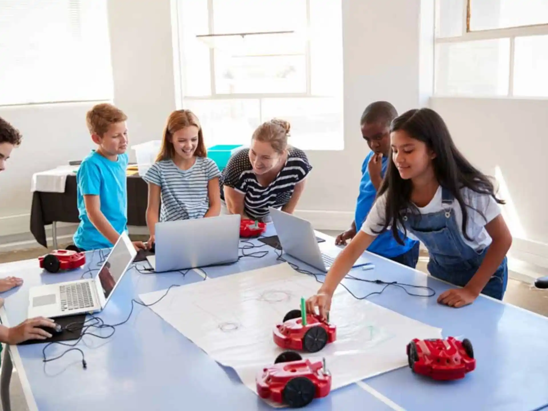 a group of people working on laptops