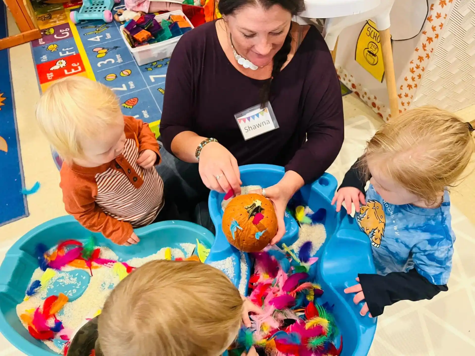 a woman and children playing with a toy