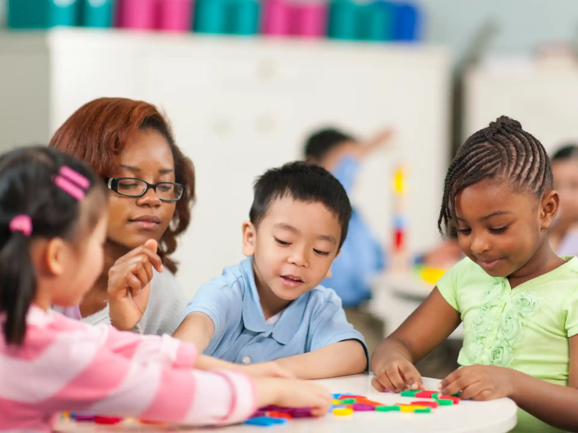 a group of children sitting at a table