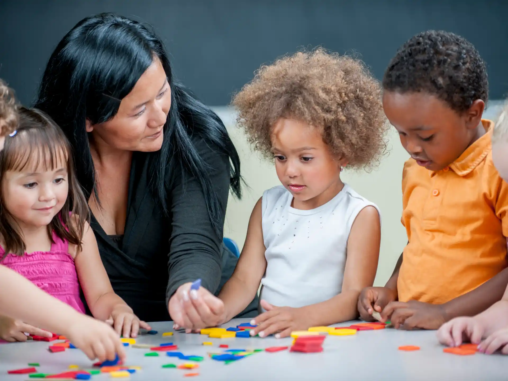 a person and several children playing a game