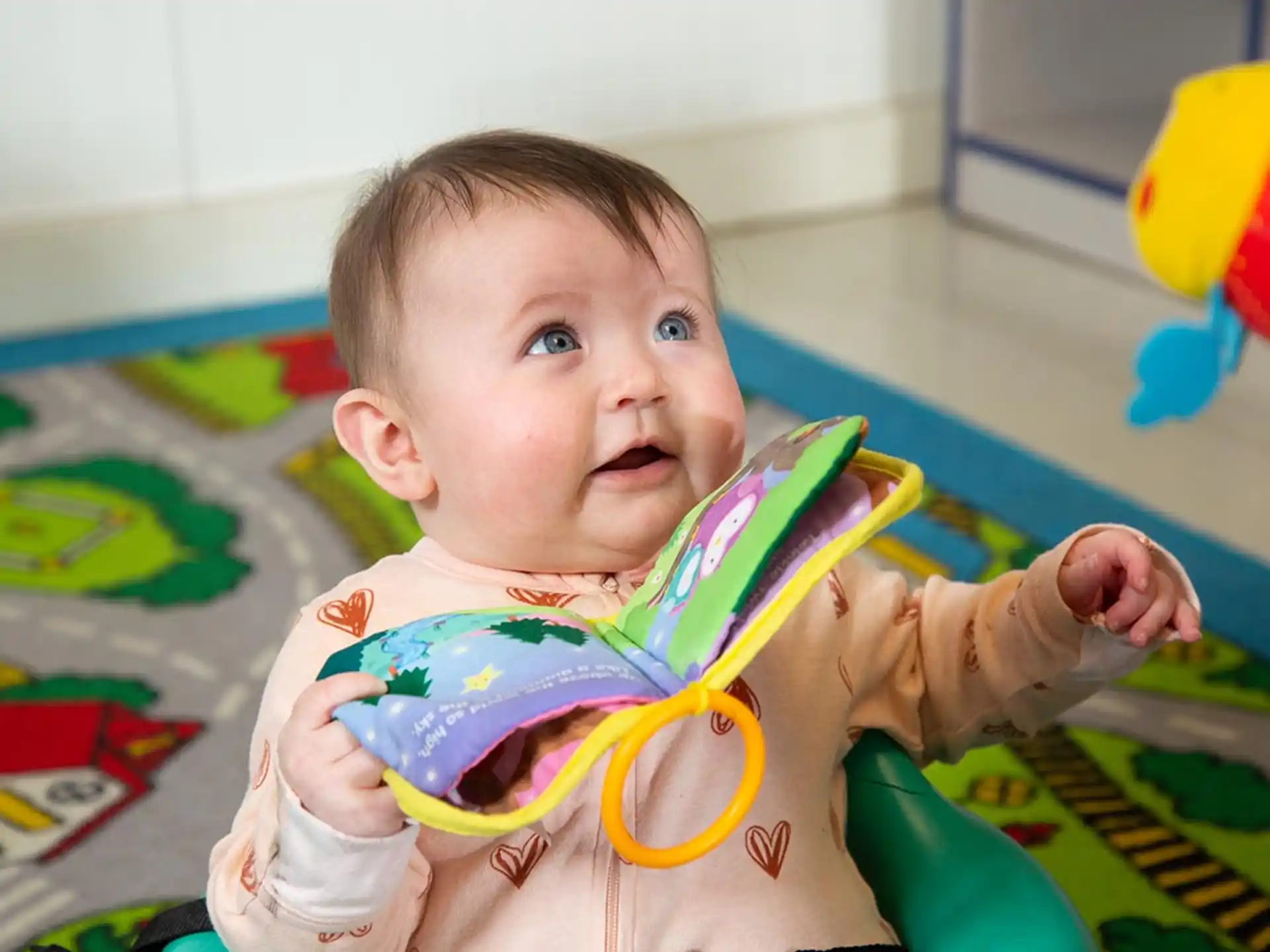 a baby holding a toy