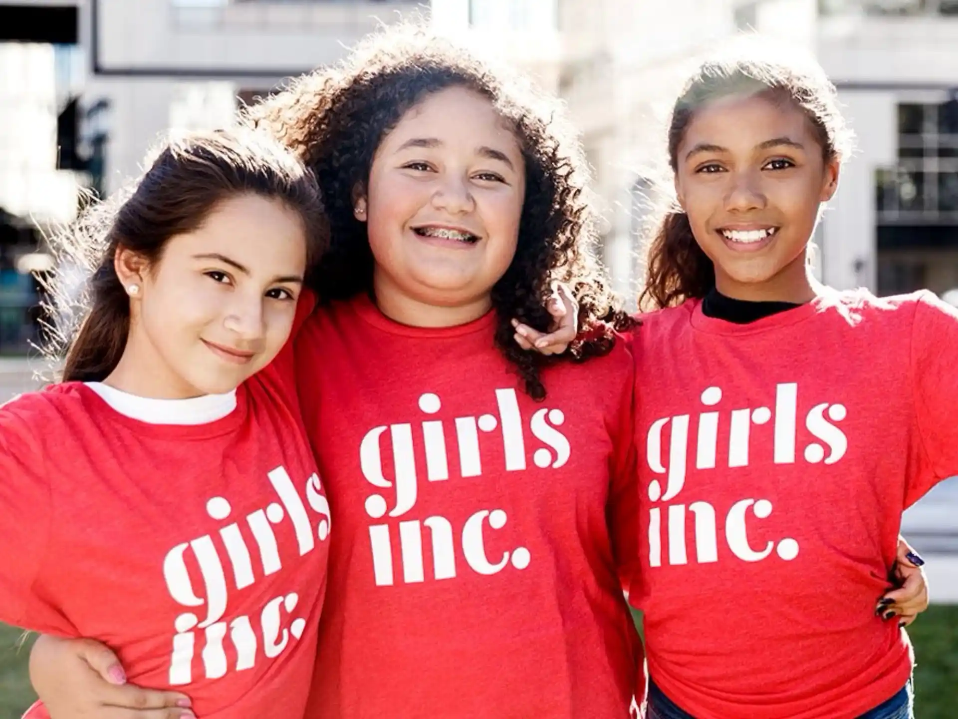 a group of girls in red shirts