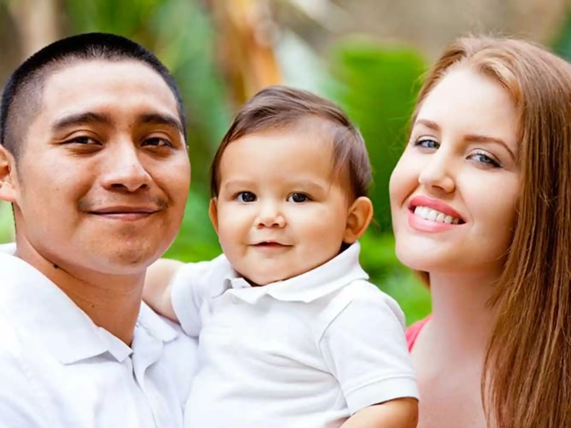 a man and woman holding a baby