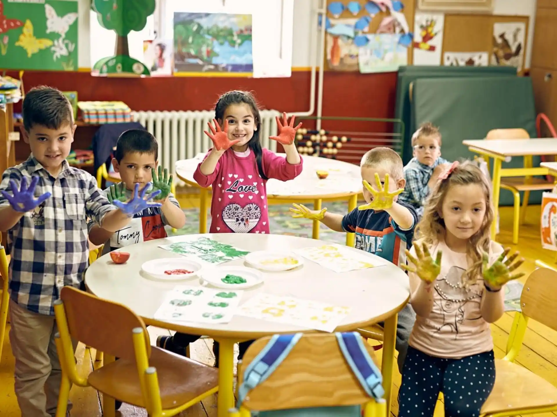 a group of children sitting at a table