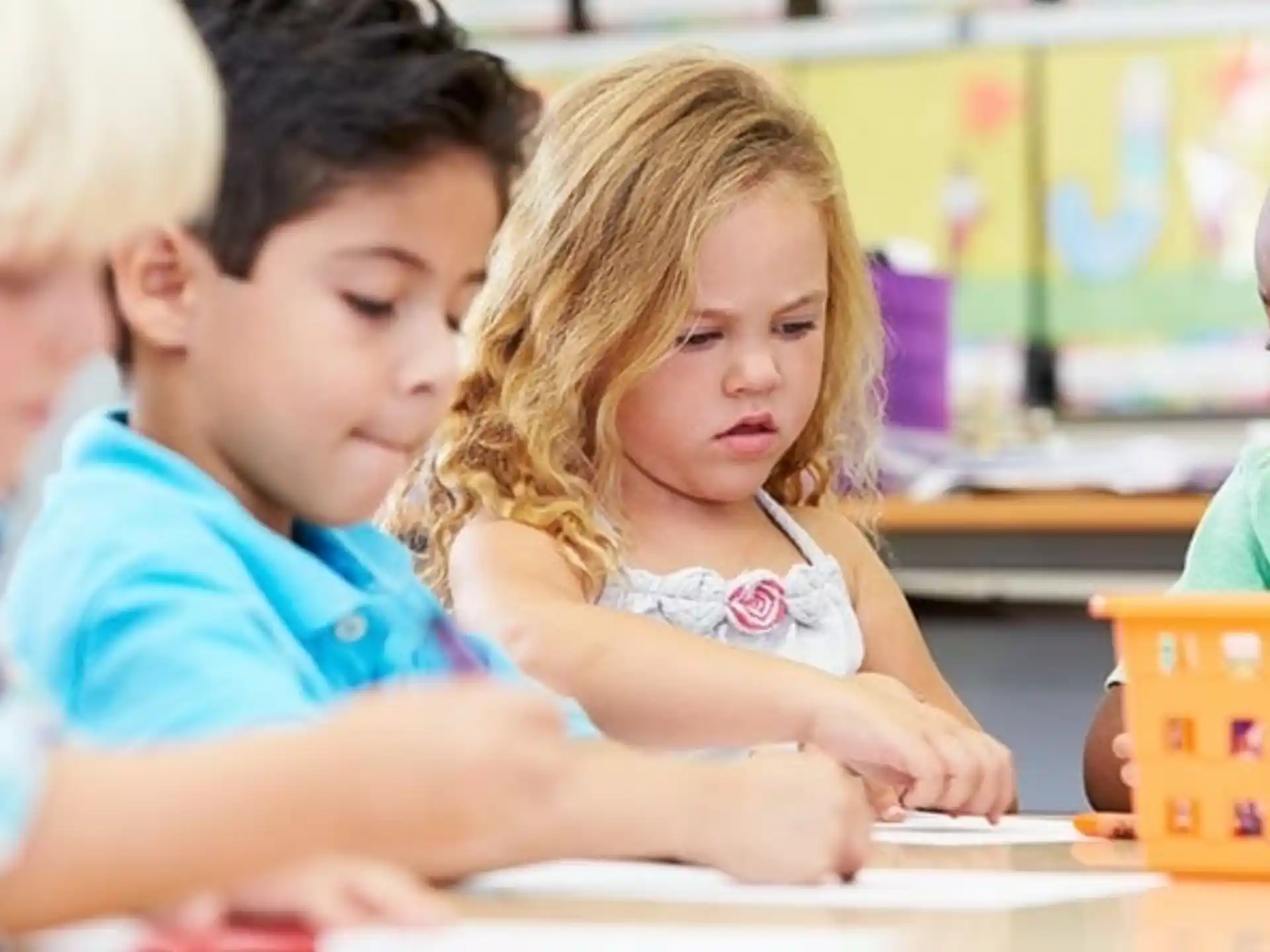 a group of children sitting at a table