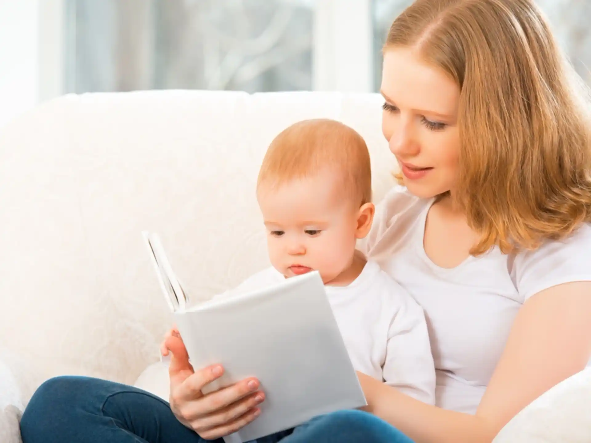 a person and a baby looking at a tablet