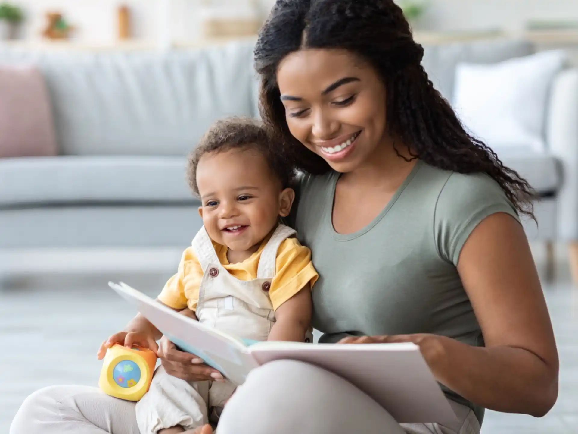 a person reading a book to a baby